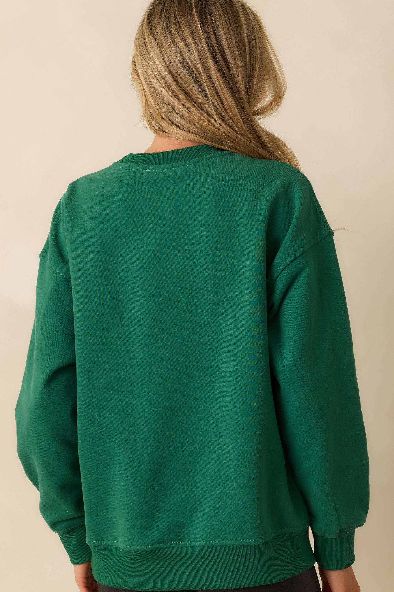 Simple forest green sweatshirt with smooth fabric and ribbed trim at the rear.