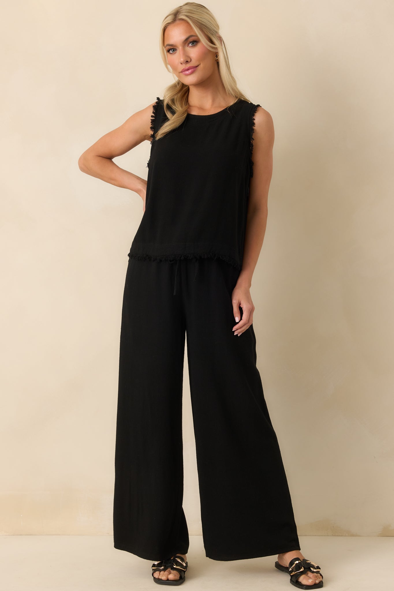 Front view of the black pants highlighting the high waisted fit and wide leg silhouette.