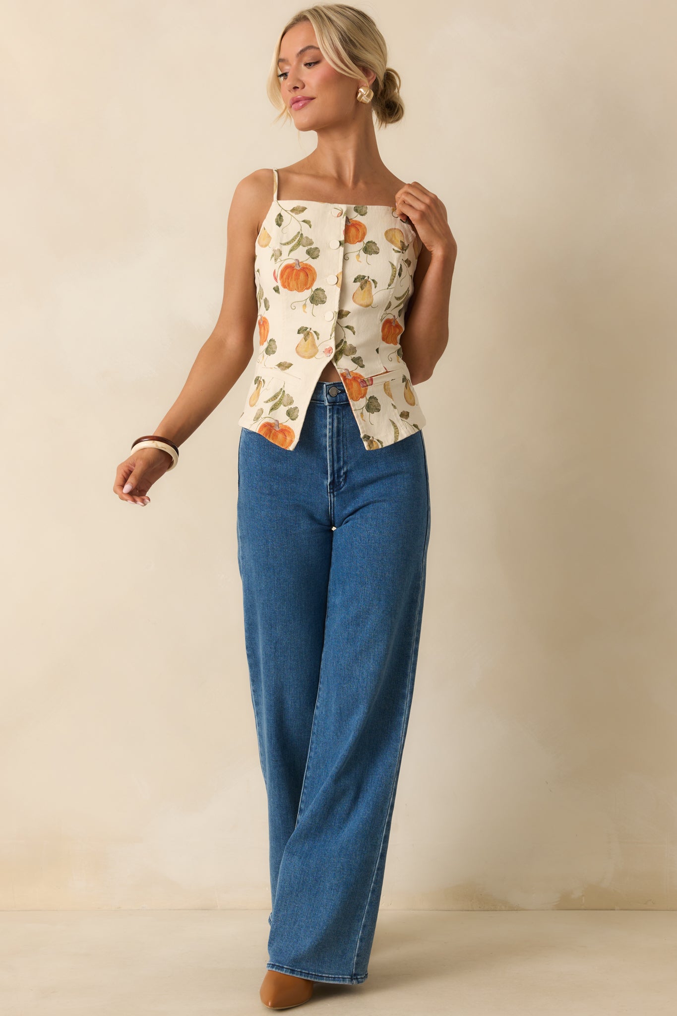 Full frontal display of ivory waistcoat-inspired blouse featuring fitted silhouette and garden motif.