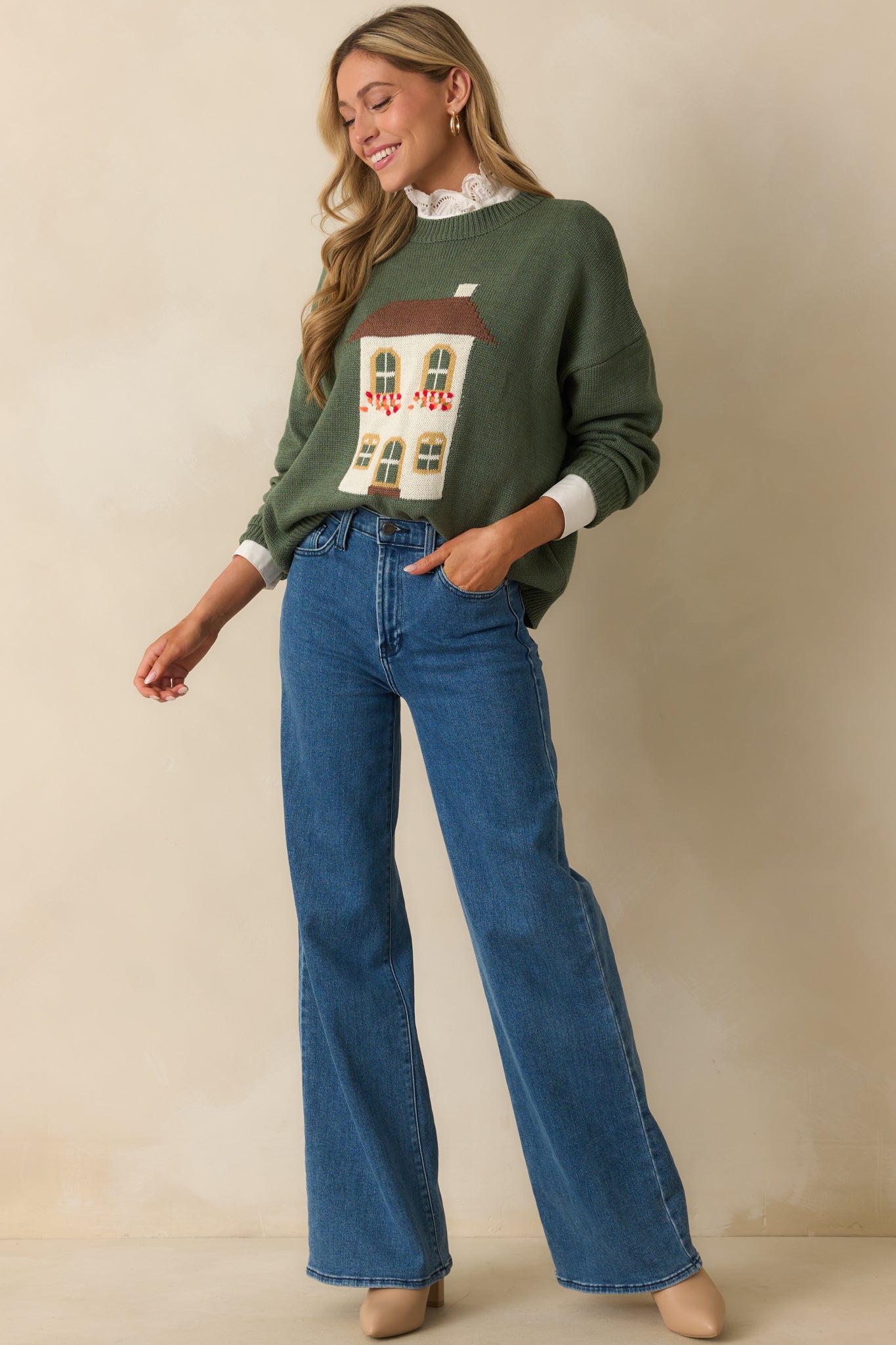 Full frontal look at green cotton-blend sweater with cozy crew neck and motif design.