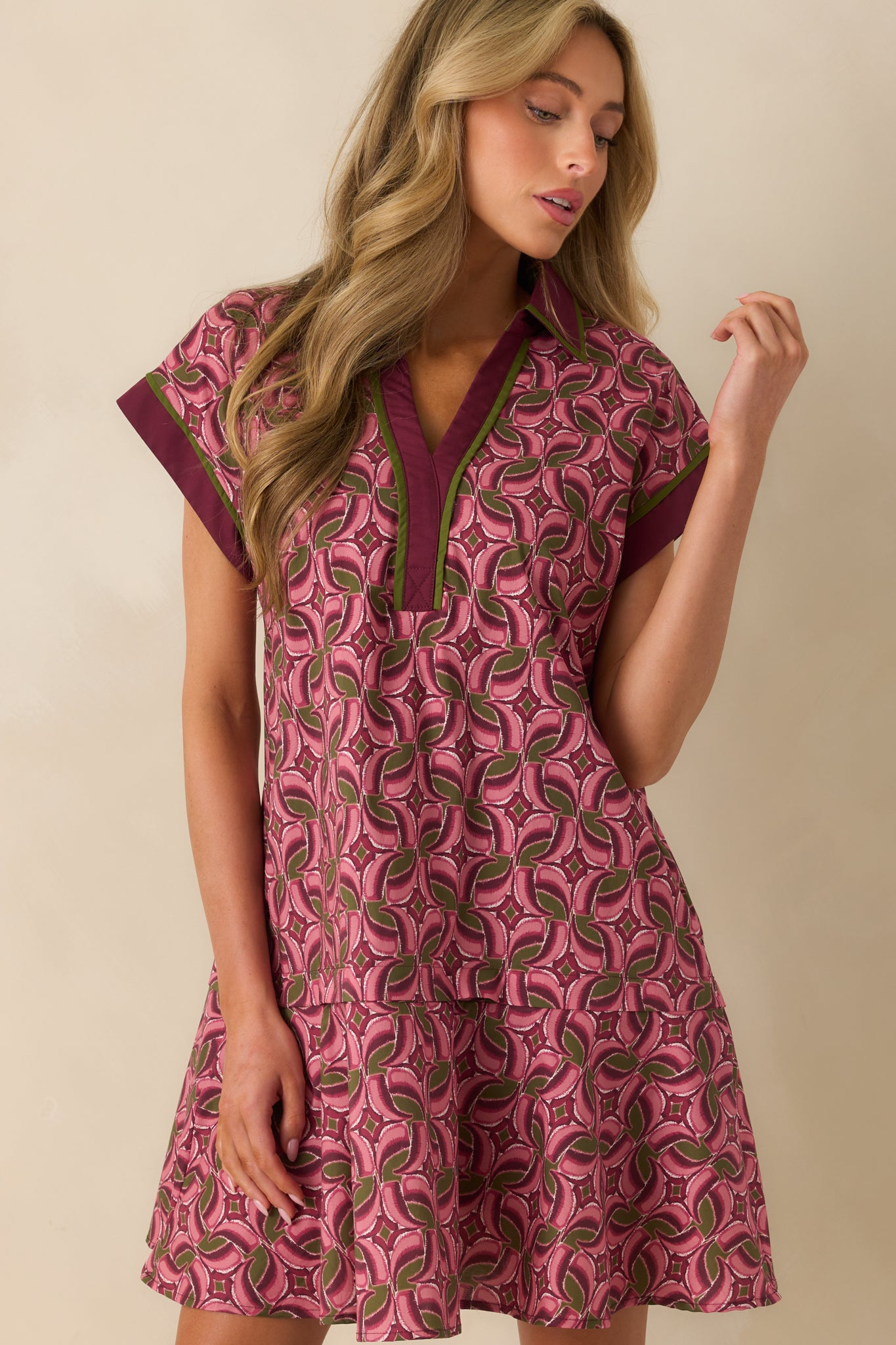 Tiered skirt layers highlight the flowy shape of the geometric mini dress.
