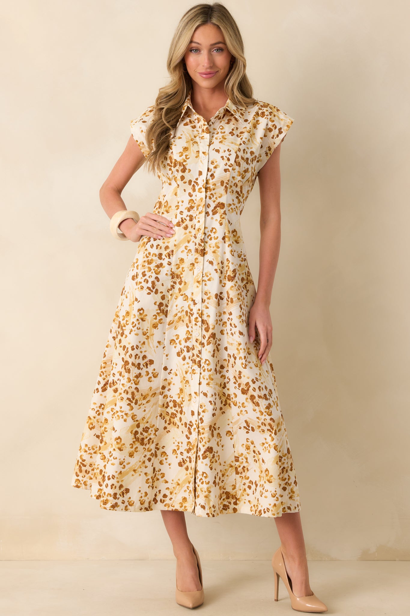 Golden yellow maxi dress with abstract animal print and structured collared neckline.