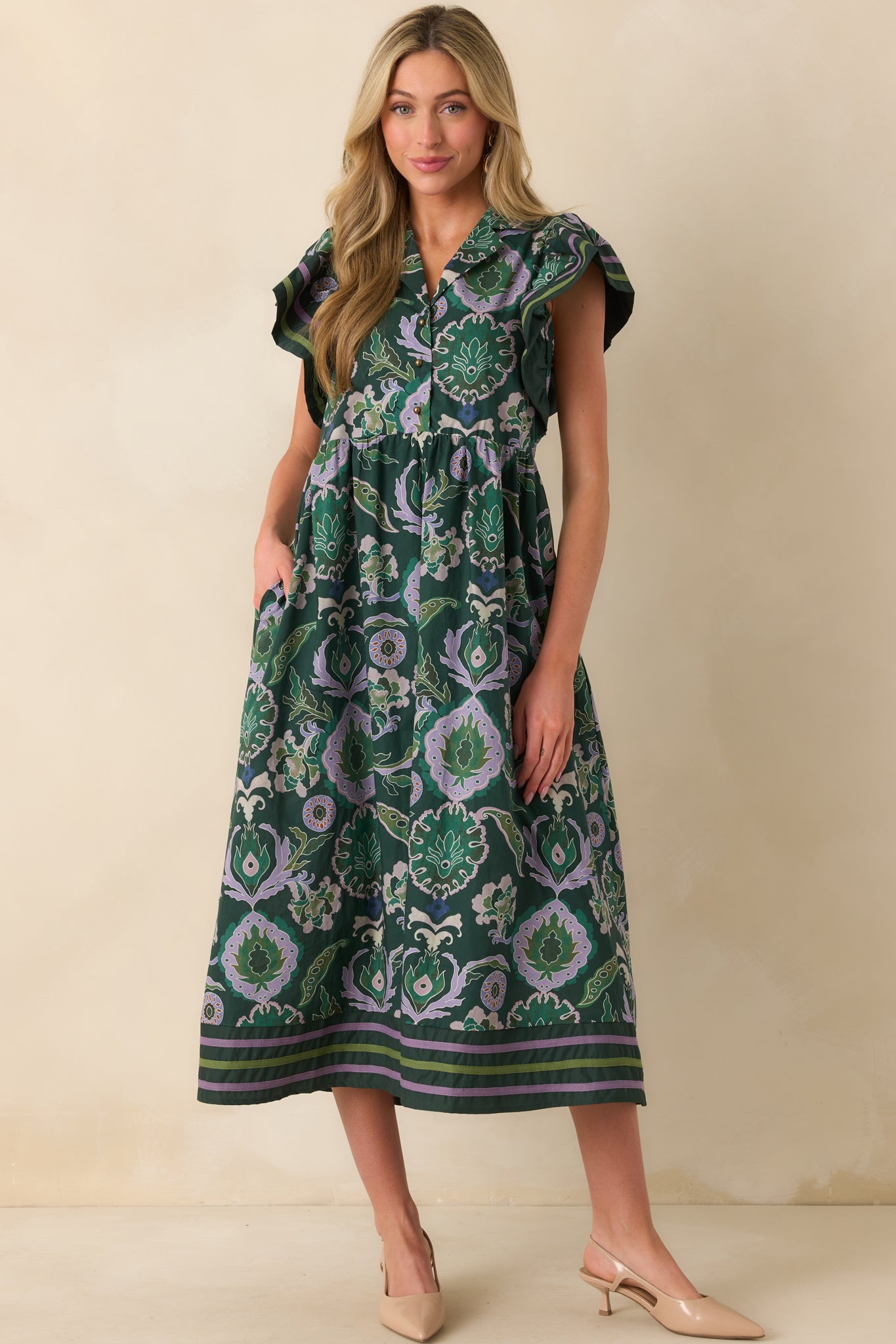 Straight-on full body image emphasizing the green and purple trim details and the relaxed midi-length skirt.