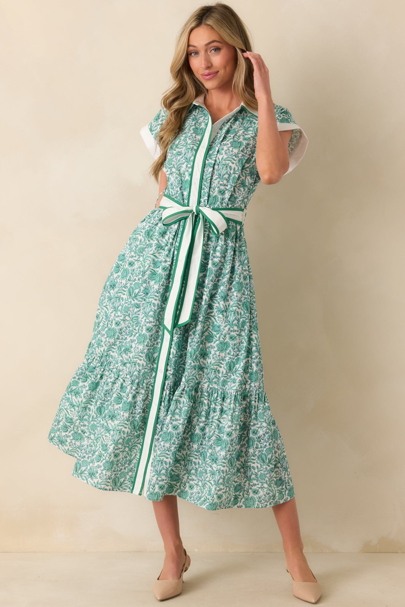 Front angle of the green midi dress showcasing the white collar, floral pattern, and button details