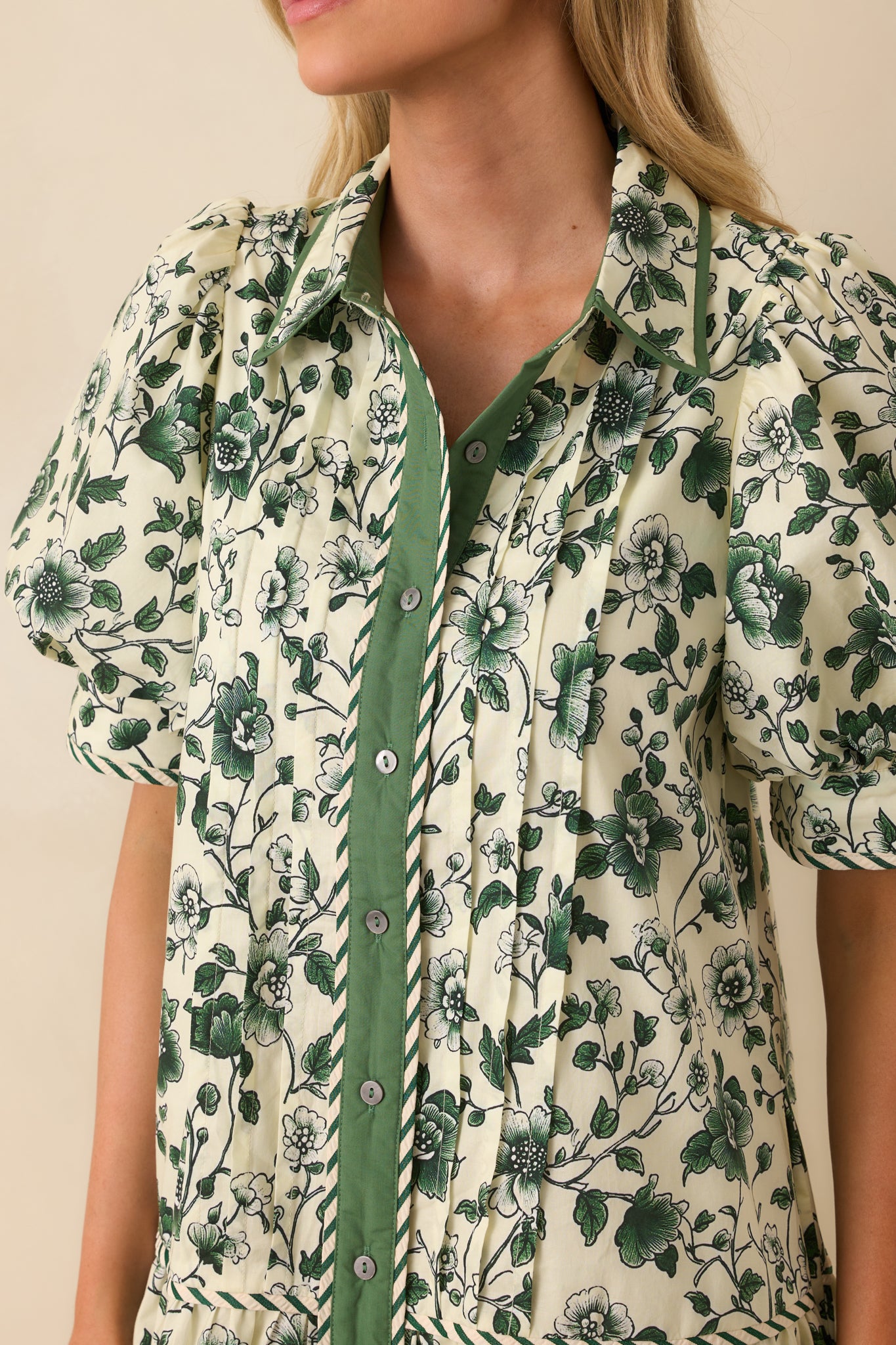 A close-up of the stripe trim accents and fine vertical pintucks on the front panel.