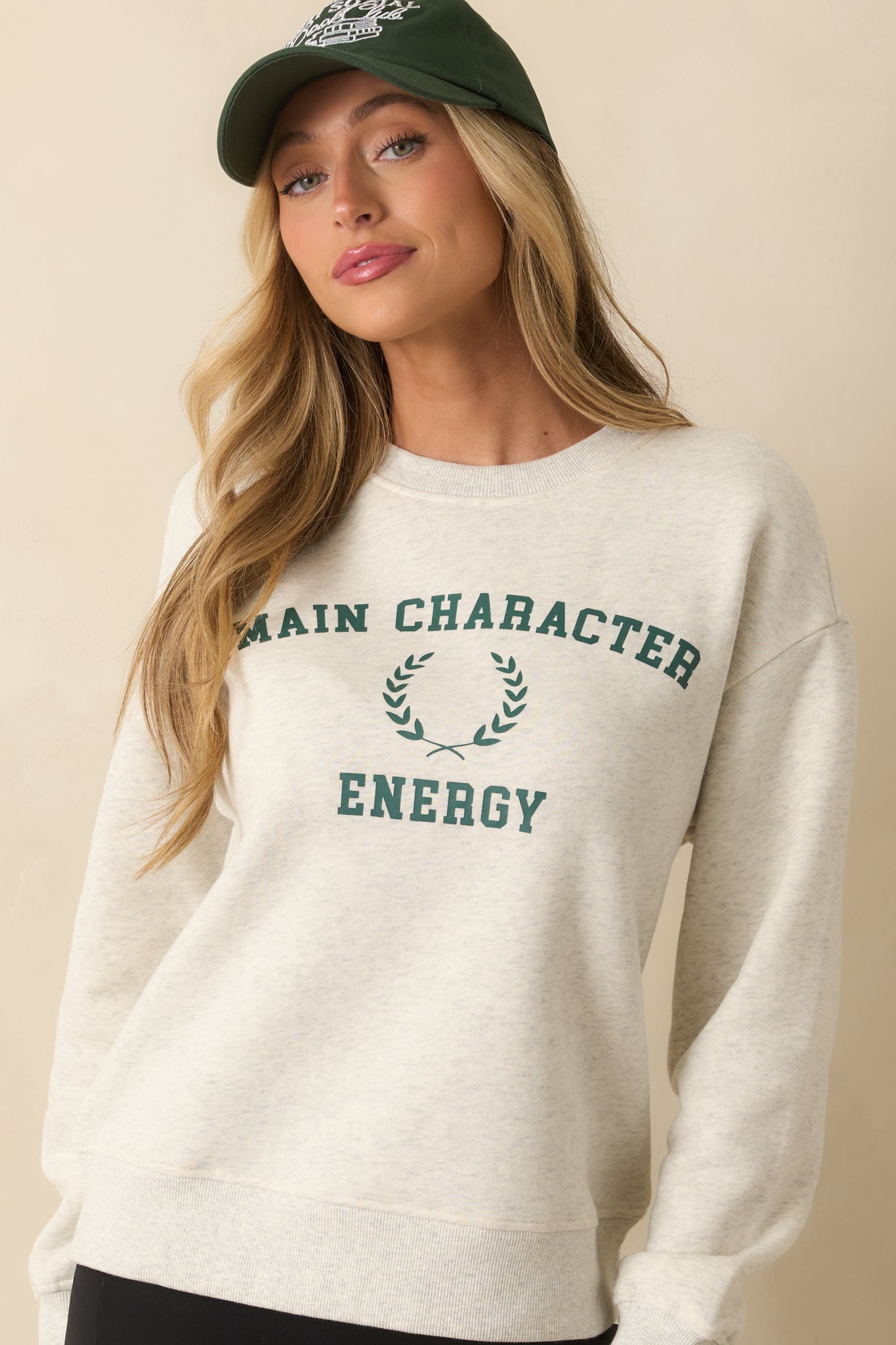 Grey crewneck sweatshirt highlighting ribbed hem and long sleeve finish.