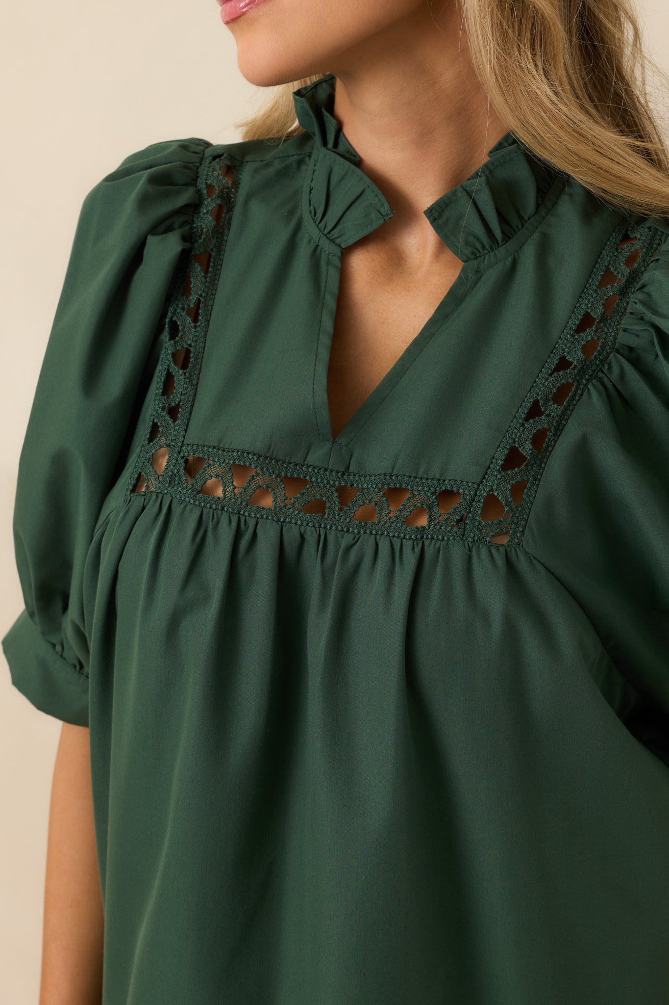 Intricate ladder lace insert shown against the rich hunter green fabric.