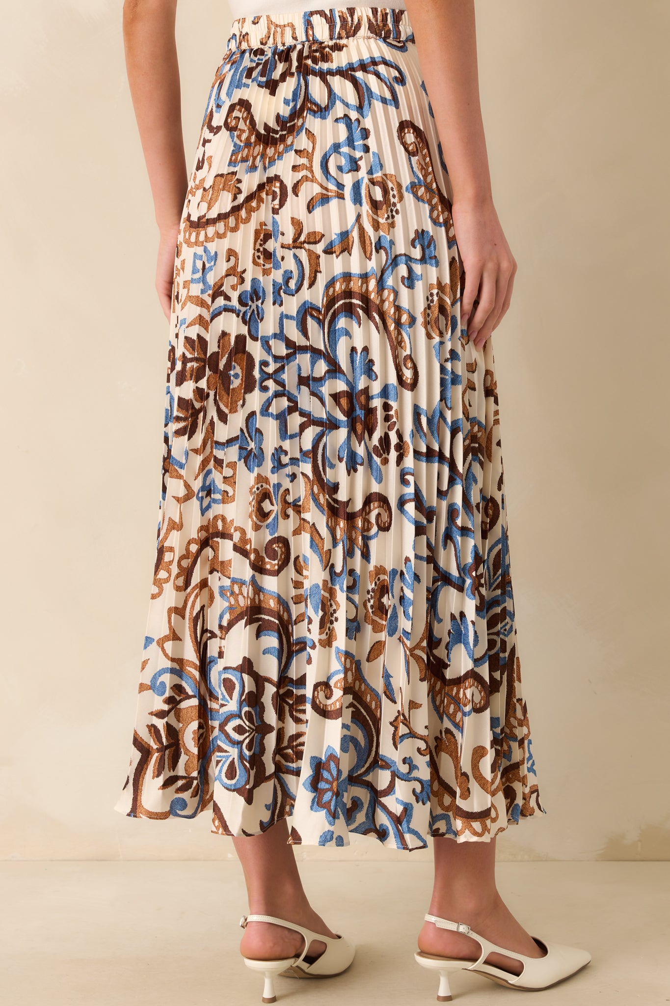 A view from behind of the skirt showing the elastic waist insert and pleats.