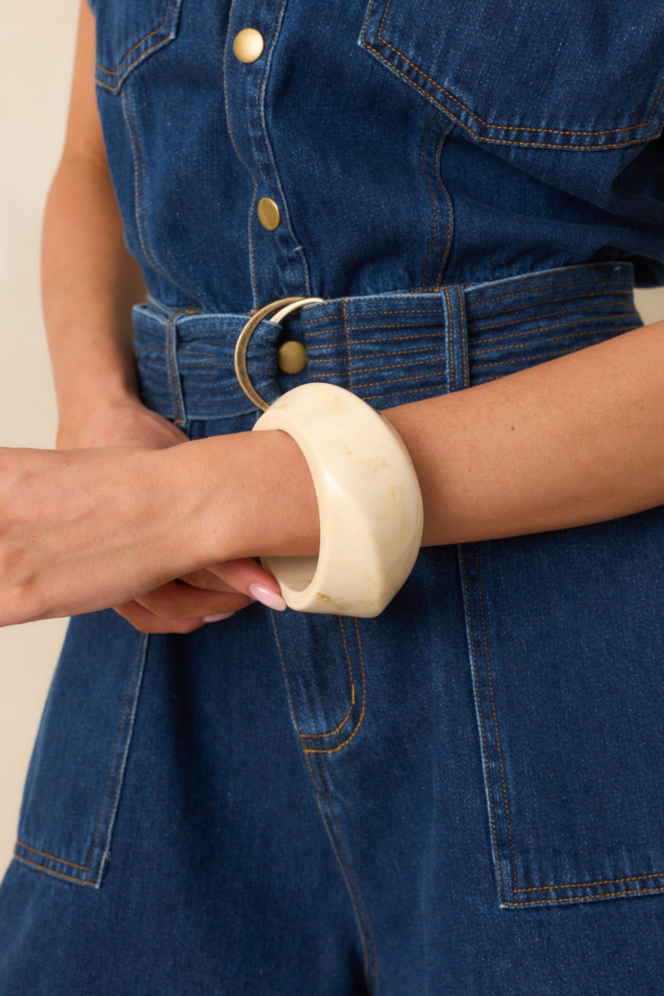 A front angled view showcasing the thick structure and marbled ivory texture of the bracelet.