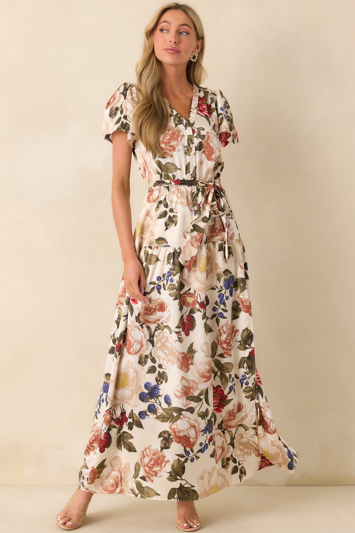 An angled full body shot capturing the multicolor floral print and ivory base of the maxi dress.