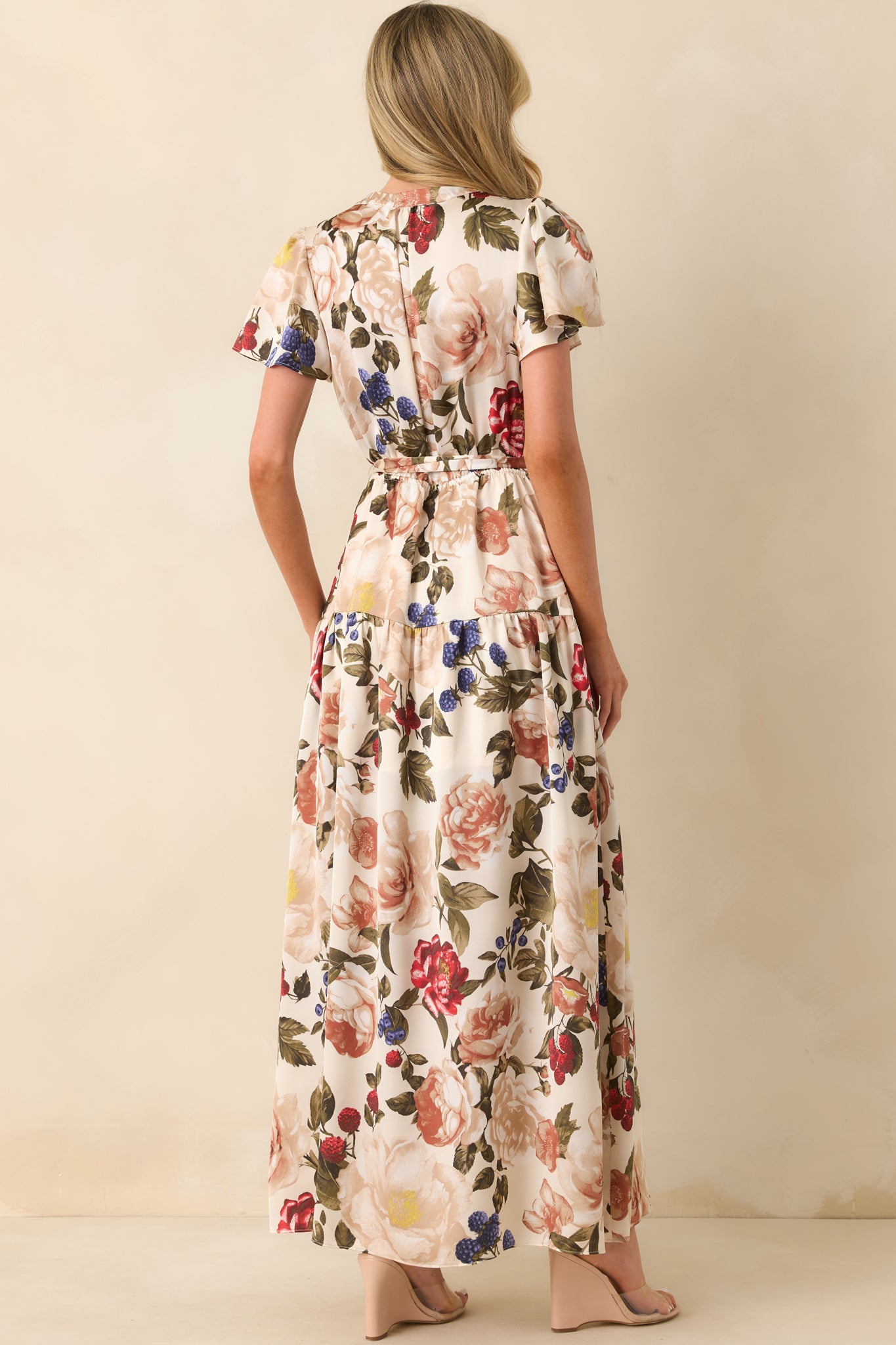 A back view of the maxi dress displaying the short butterfly sleeves and soft flow of the fabric.