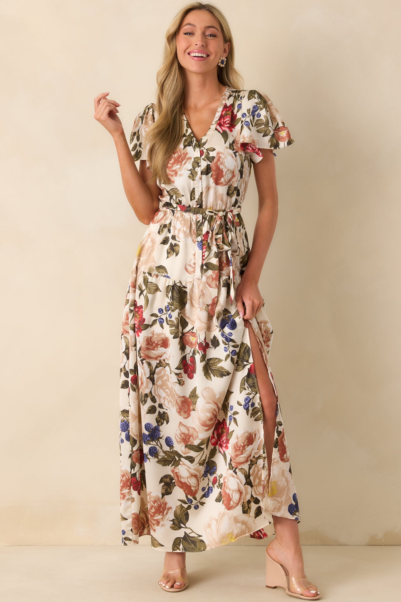 A full body view of the floral maxi dress highlighting the v-neckline and short butterfly sleeves.