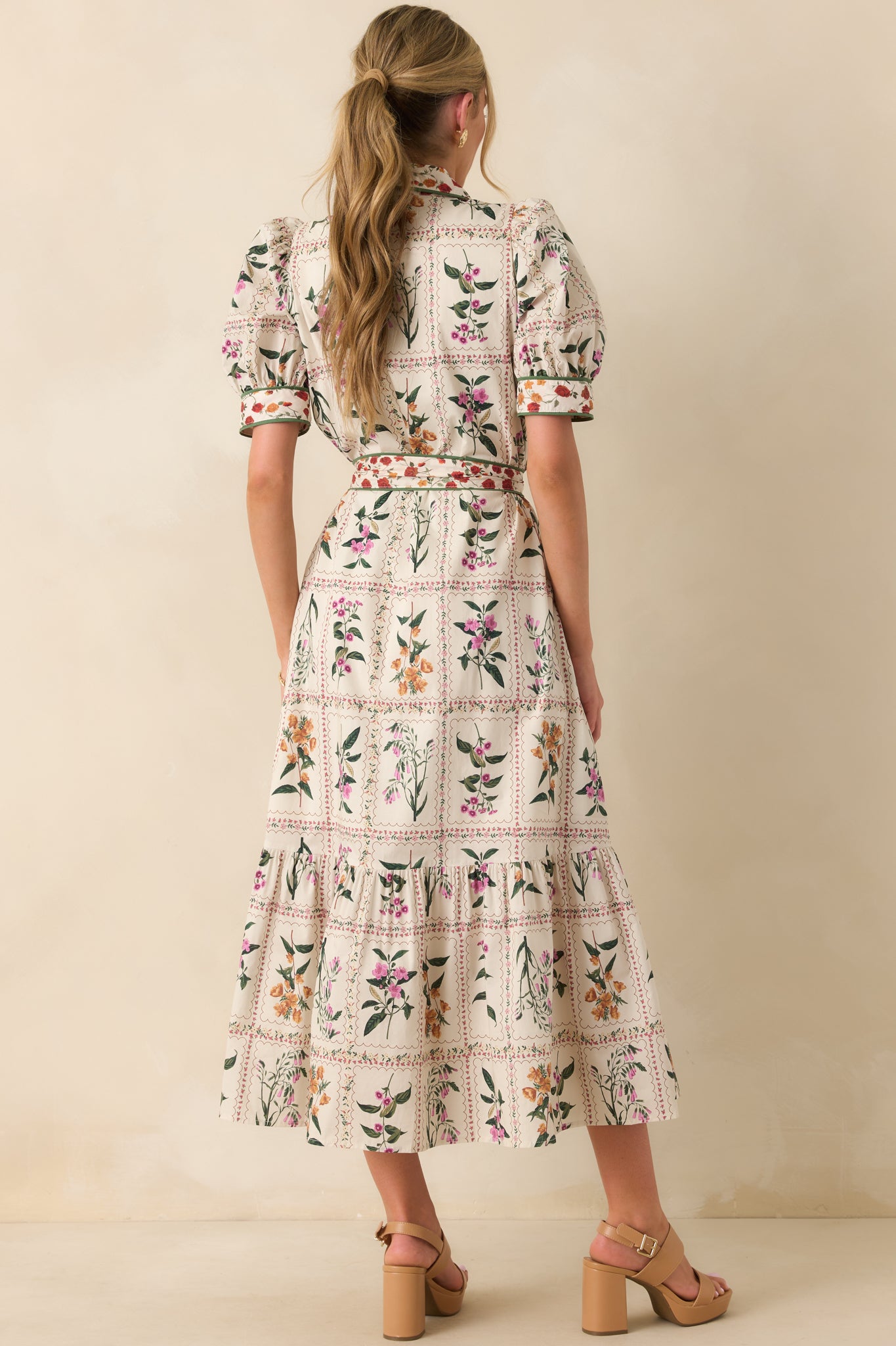 A view from behind of the maxi dress showing the collared neckline and flowing back design.