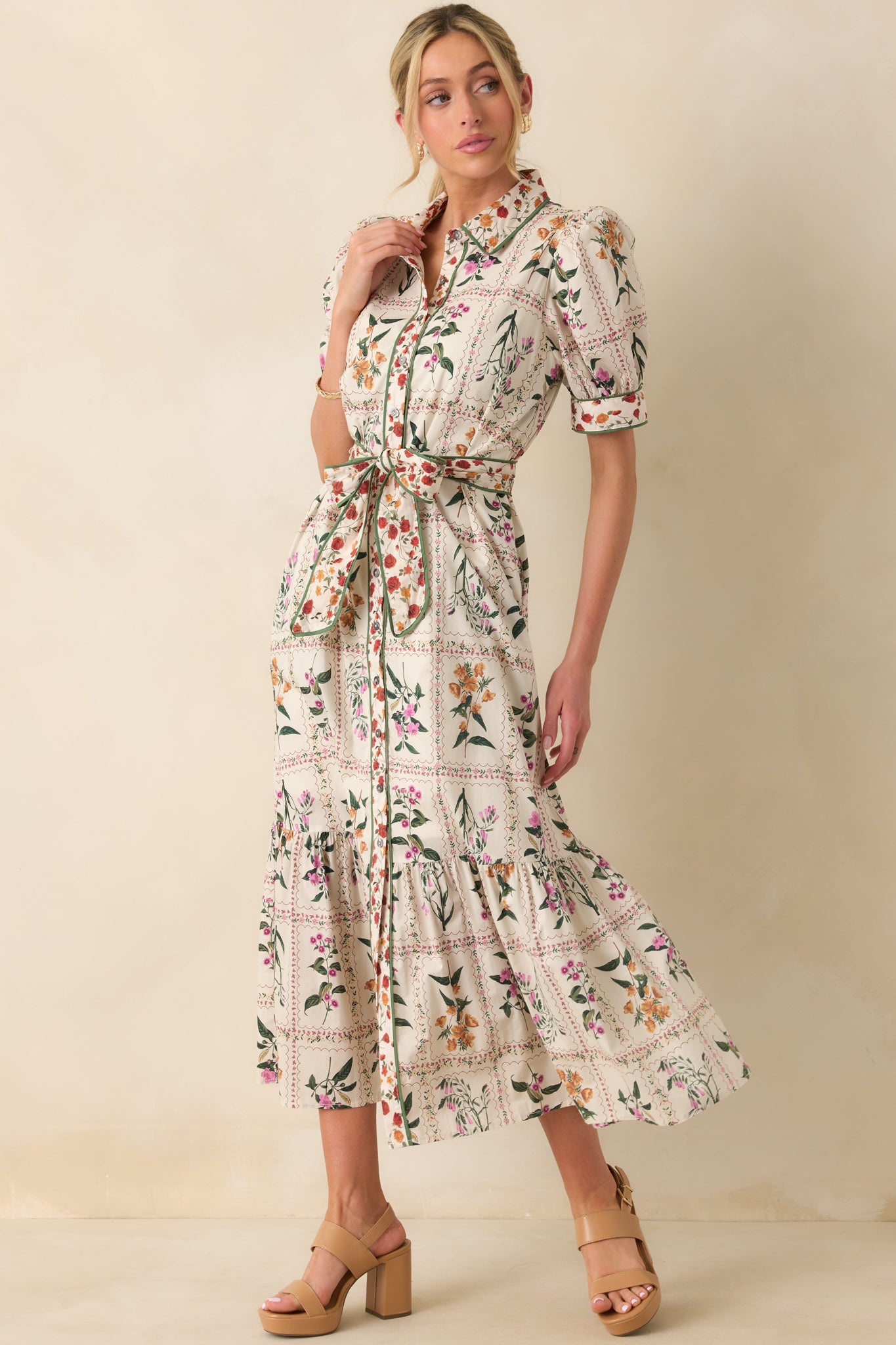 Front-facing shot highlighting the short puff sleeves and button front closure.