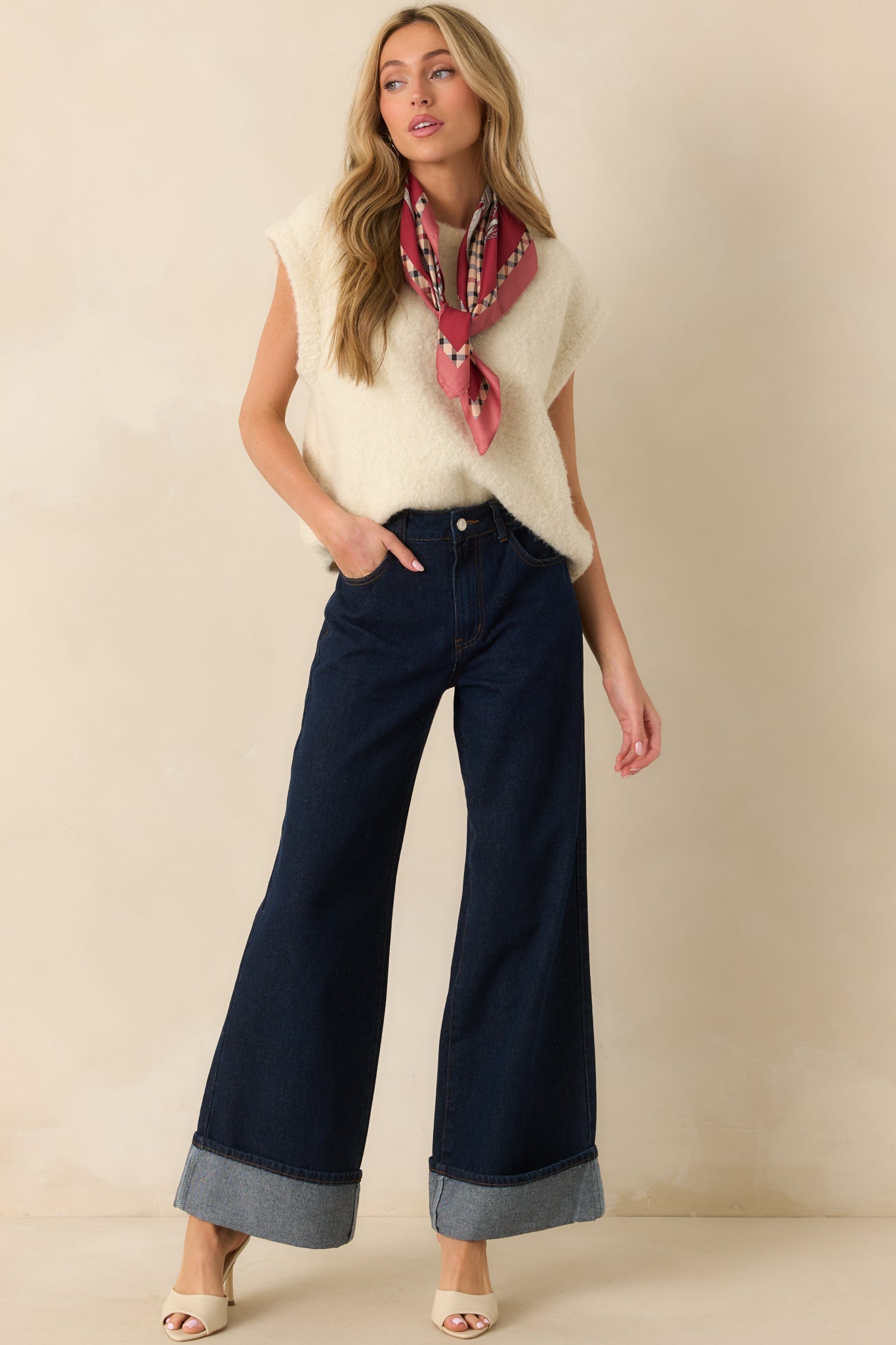 Front view of an ivory sweater vest with a crew neckline, oversized fit, and soft knit texture.