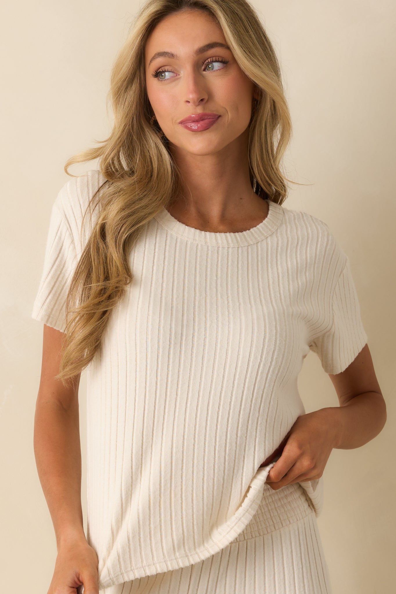 Closer view of the ivory tee showing ribbed fabric and a relaxed fit.
