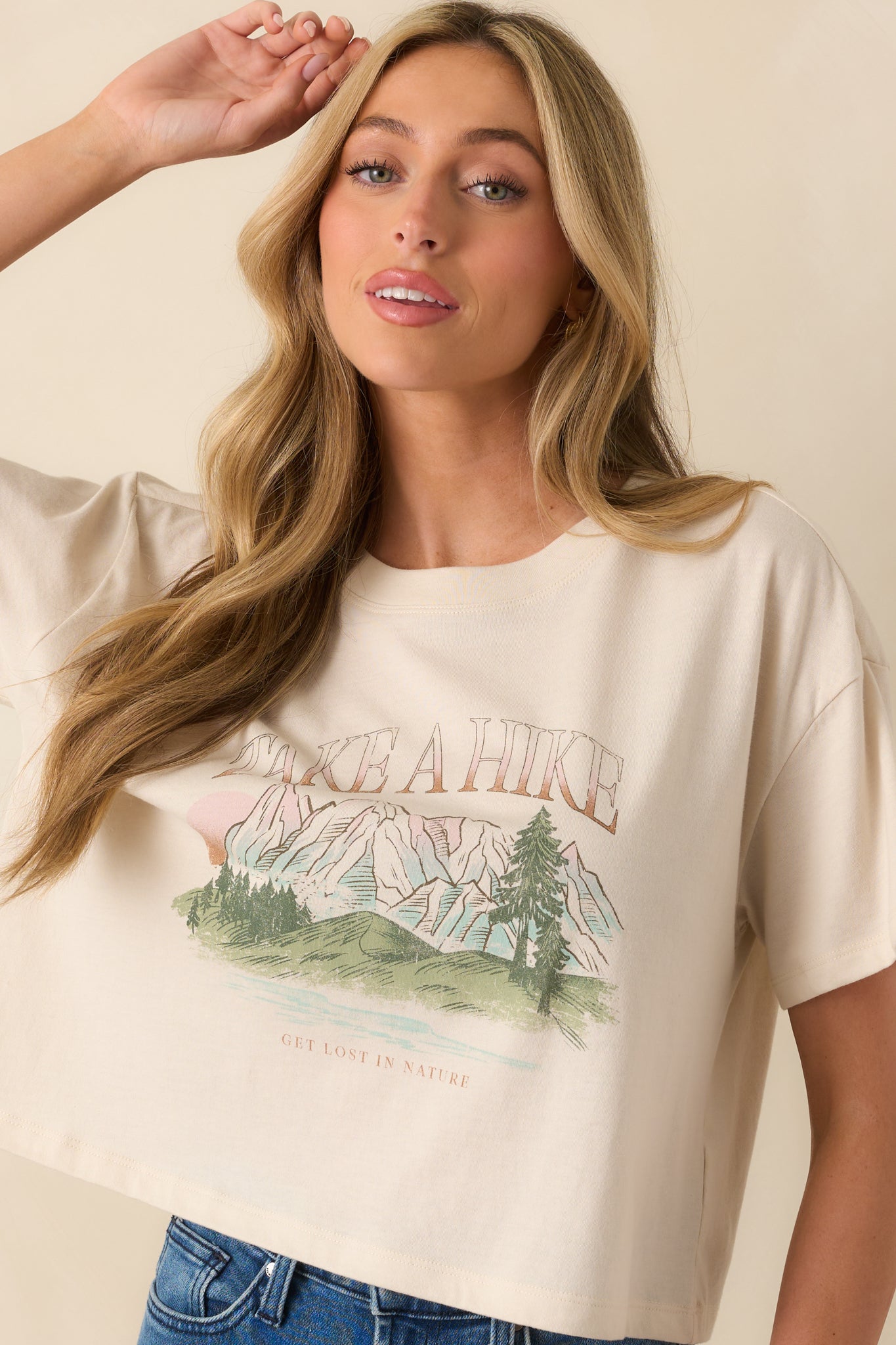 Short sleeve design of ivory tee with hiking-inspired “Take A Hike” graphic.