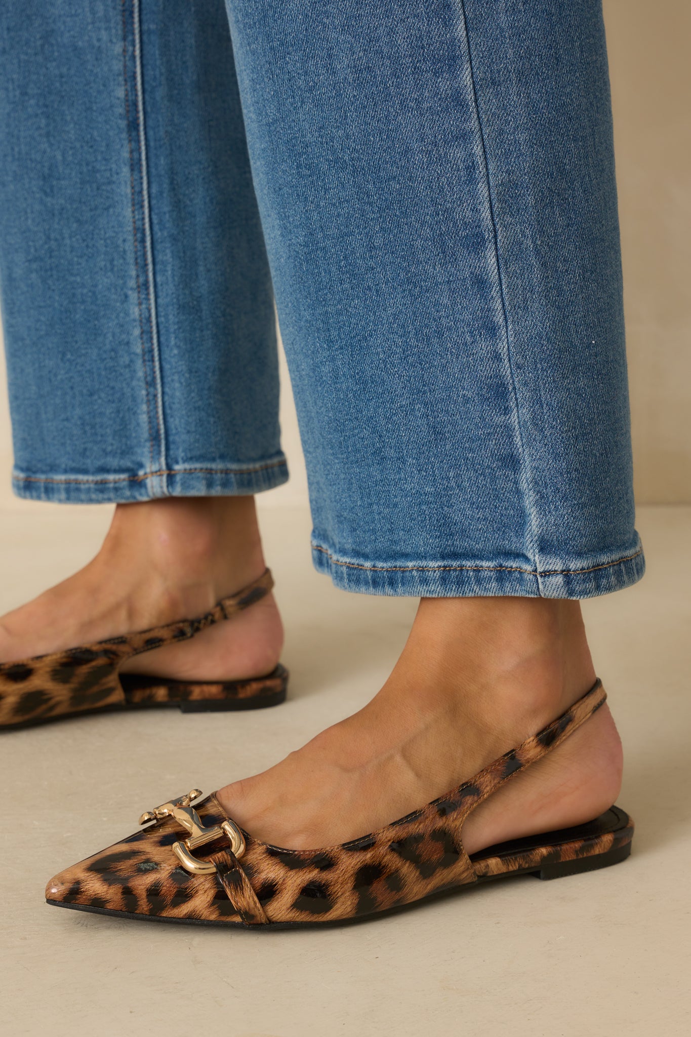 Leopard print flats with a glossy patent finish and pointed toe.