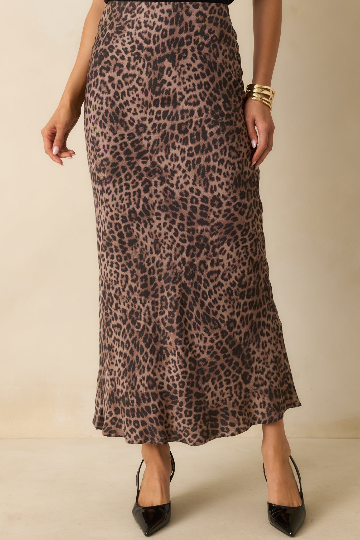 A cropped waist-down view focusing on the high-rise elastic waistband and leopard print pattern.