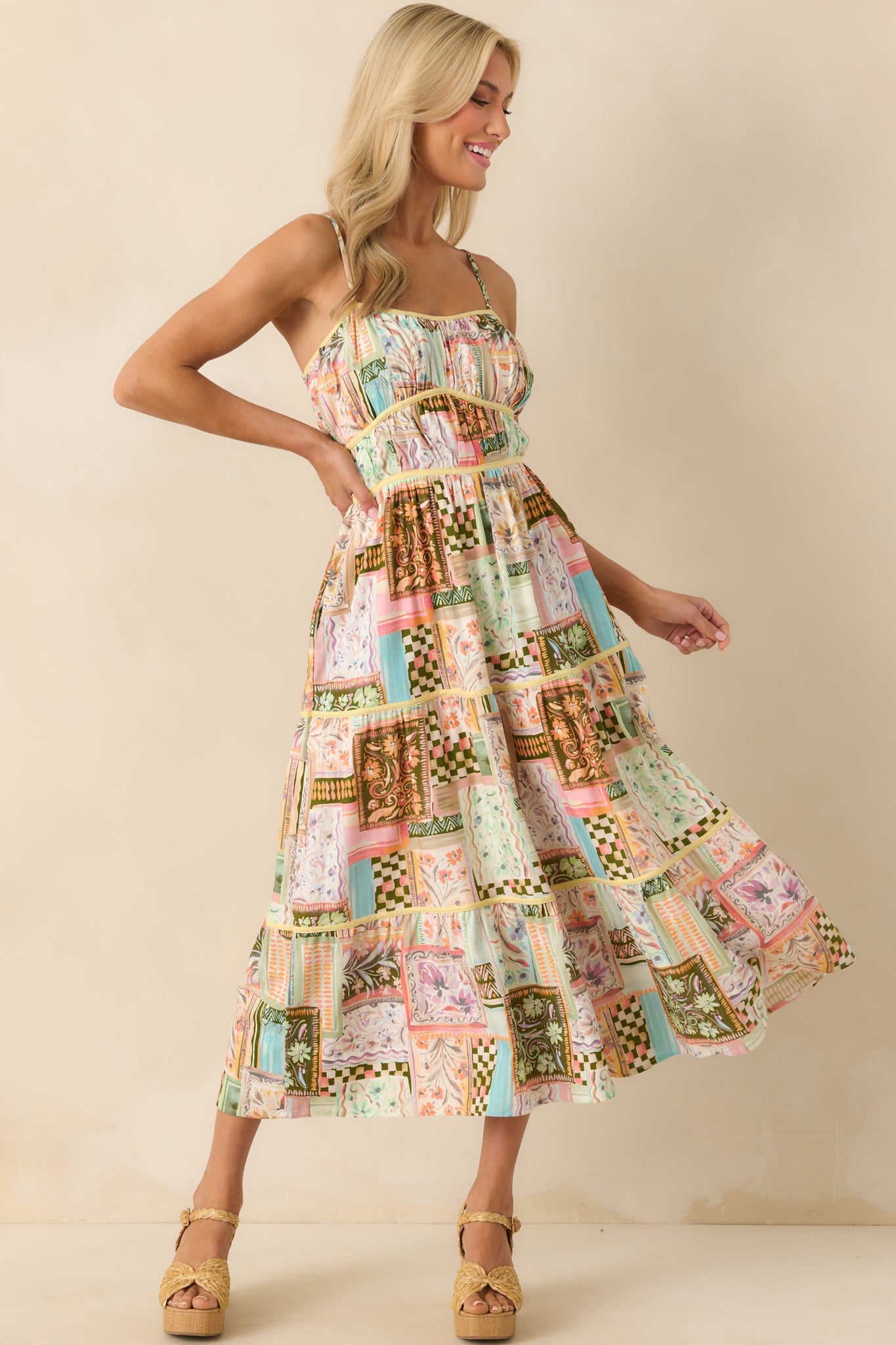 Front view of the light green maxi dress featuring a multicolor patchwork print, scoop neckline, and ruched bodice with yellow trim accents.