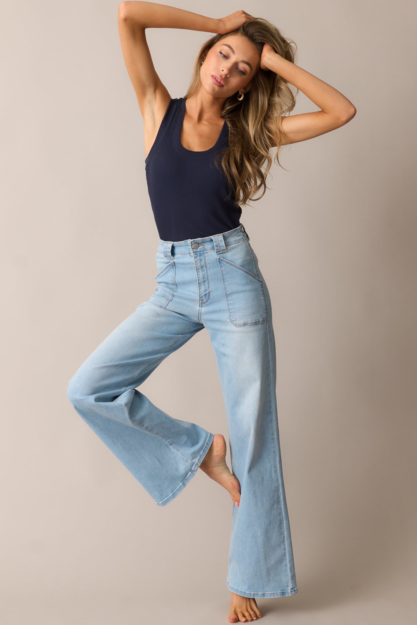 Light wash high-waisted jeans with a flared leg, front patch pockets, and a structured fit.