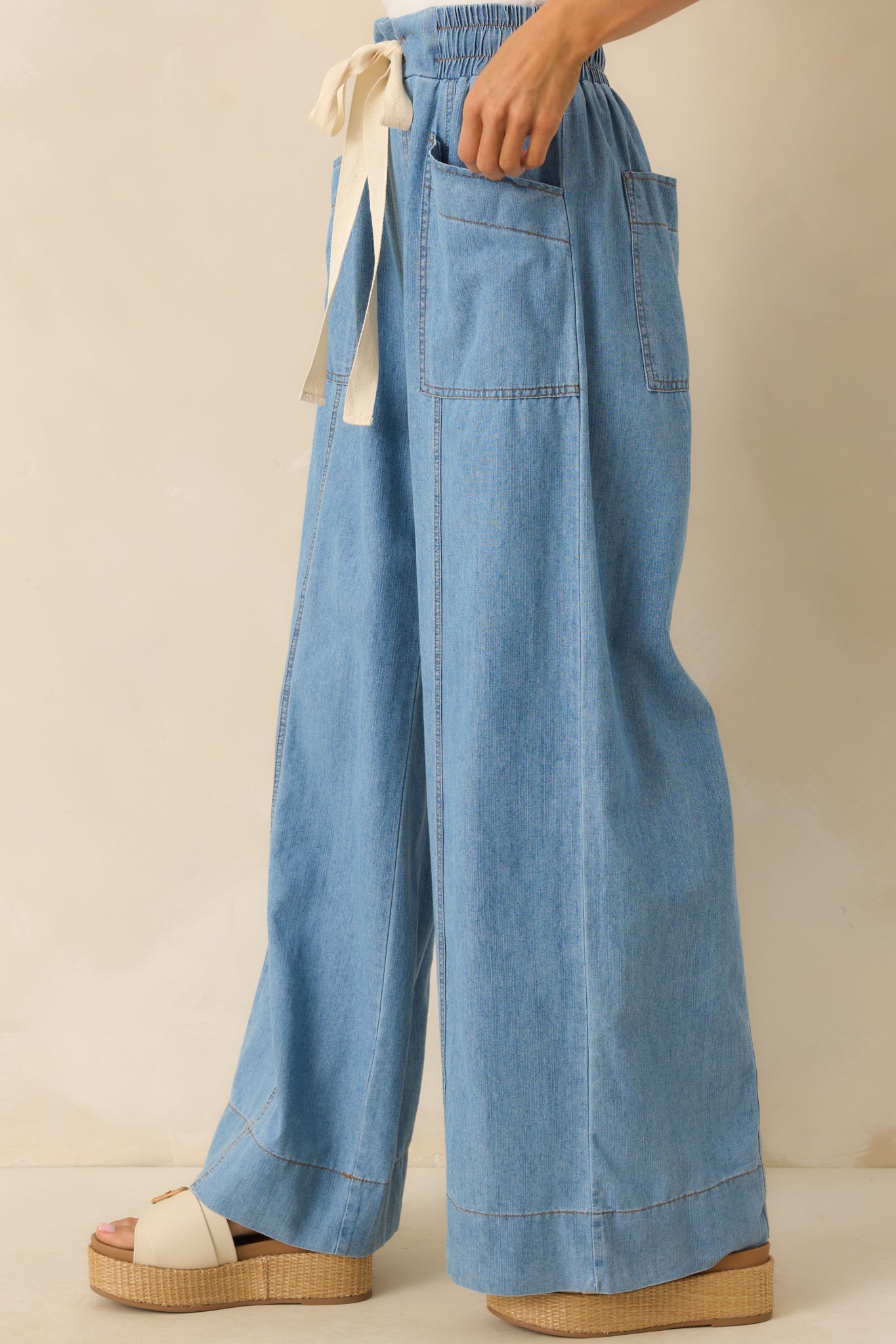 Side cropped shot highlighting the paneled construction and subtle texture of the chambray fabric.