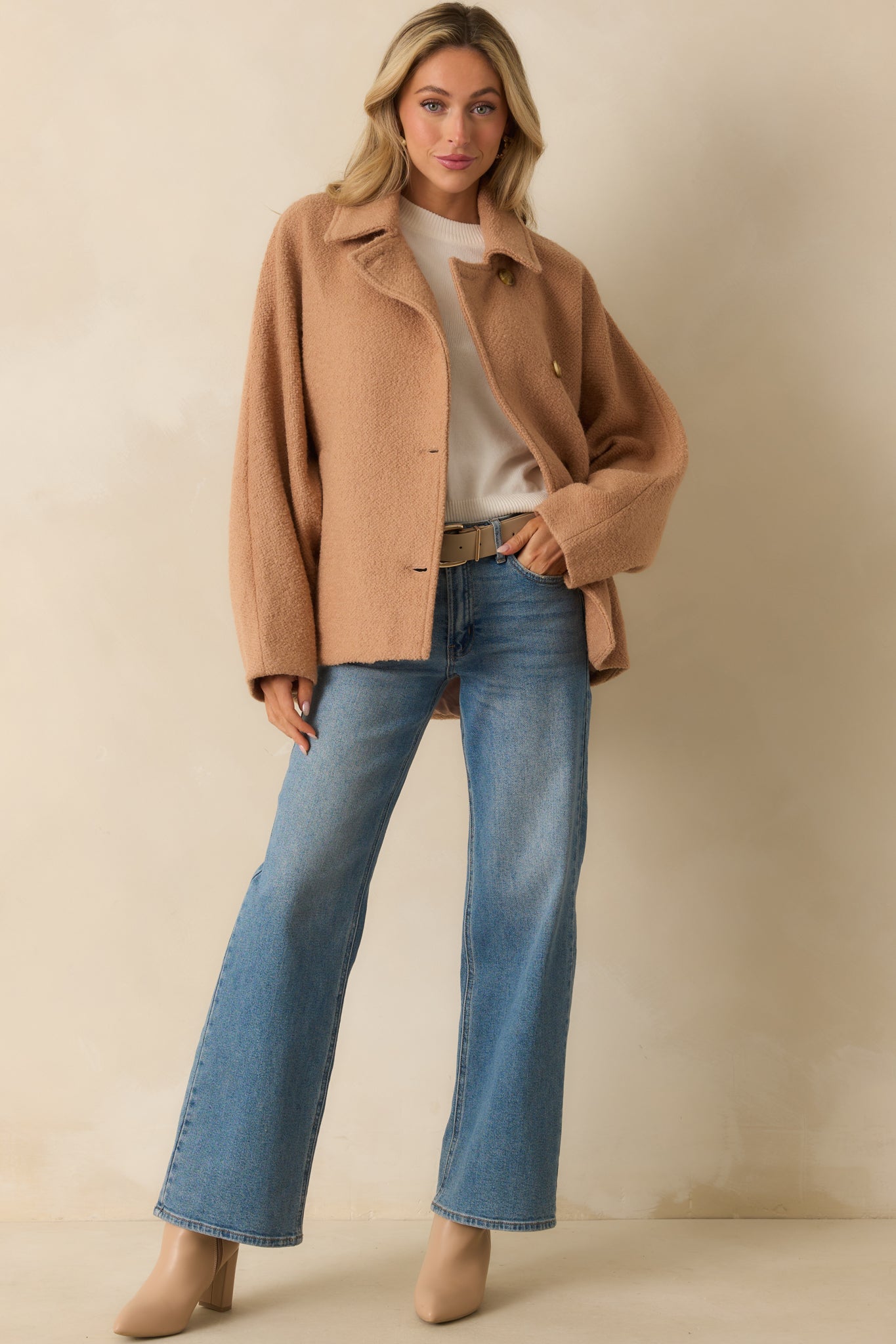 Long sleeve coat in a textured fabric with welt side pockets and a straight hemline.