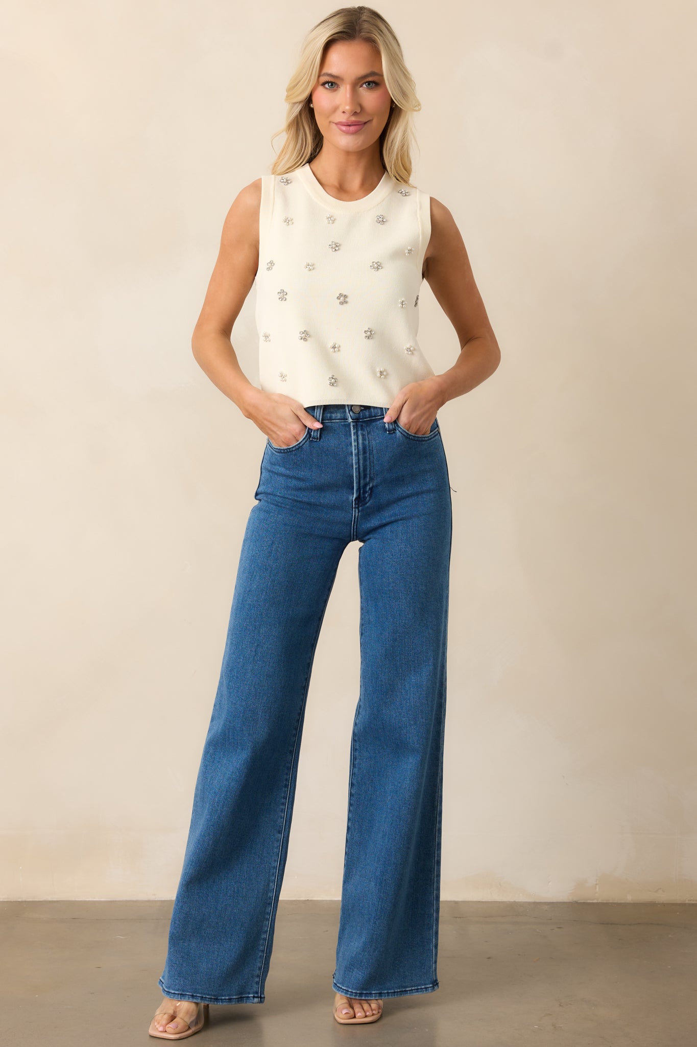 A stylish pair of high-rise jeans in a medium wash, showcasing a relaxed wide-leg fit and structured silhouette.