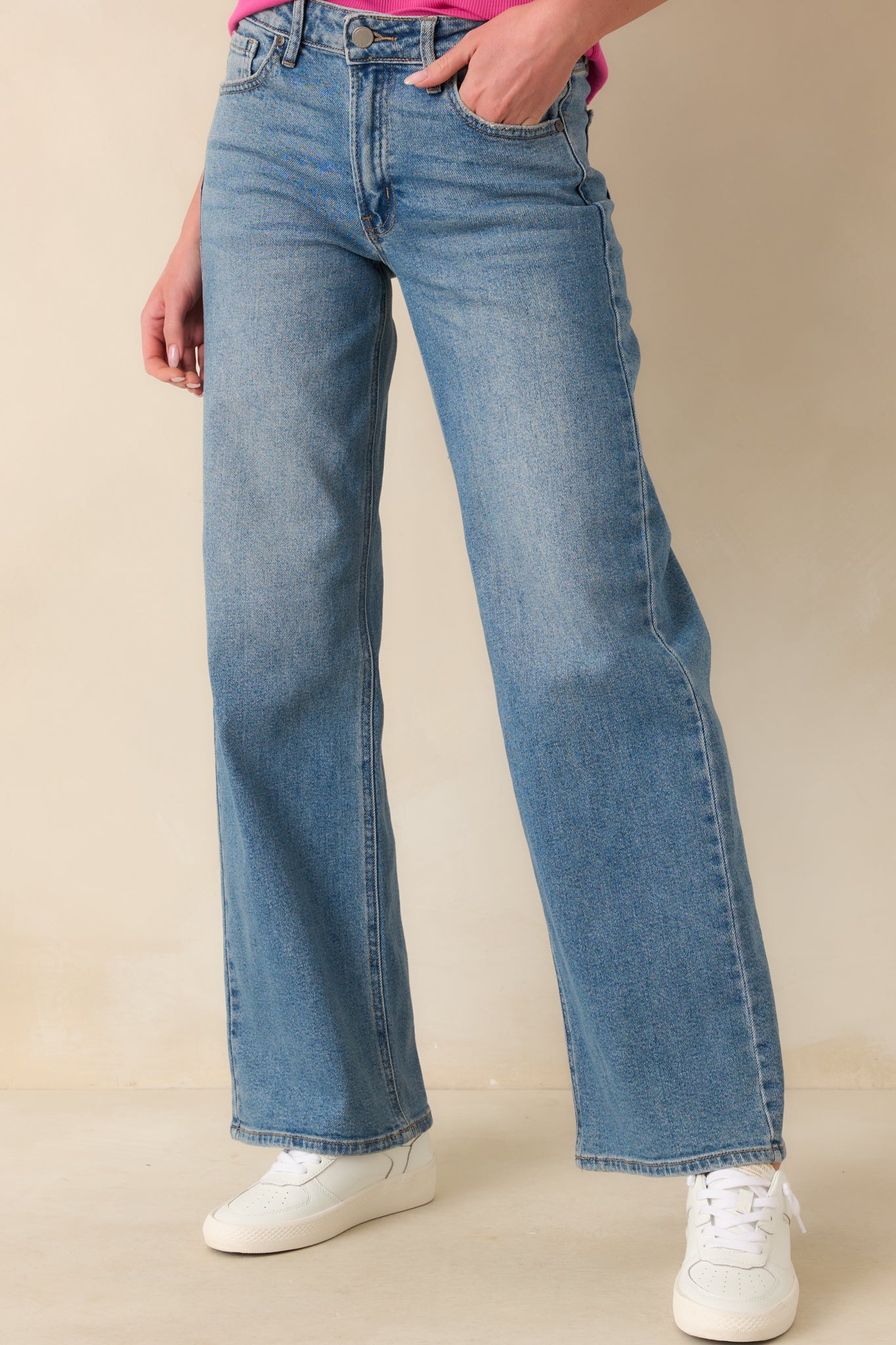A complete shot showing the jeans’ overall design with clean seams, belt loops, and wide leg cut.