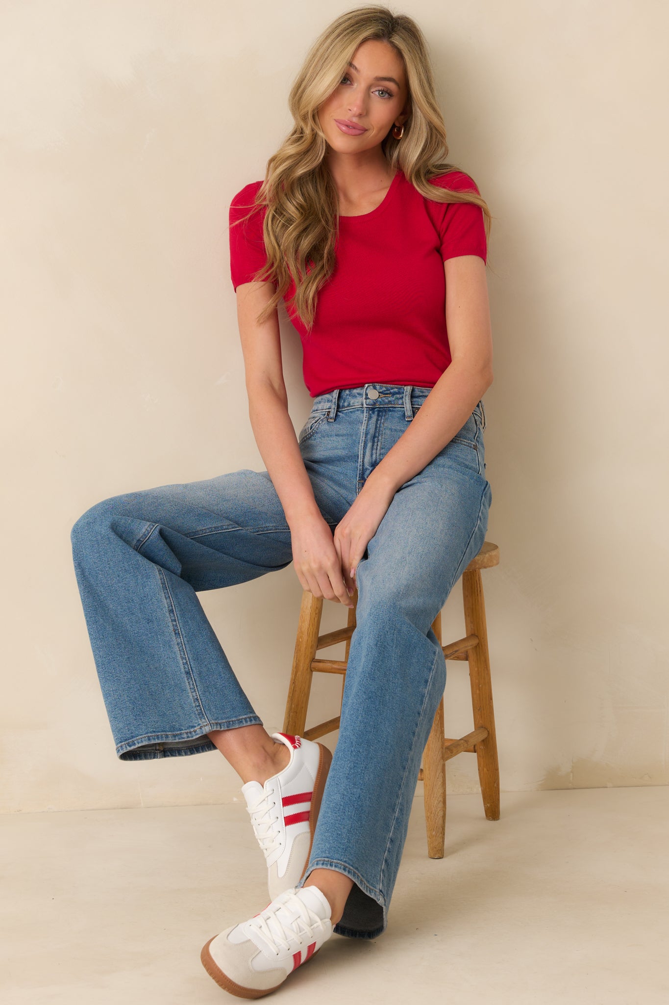 Front seated view of these jeans featuring functional belt loops, a button zipper closure, functional front and back pockets, and a wide leg.