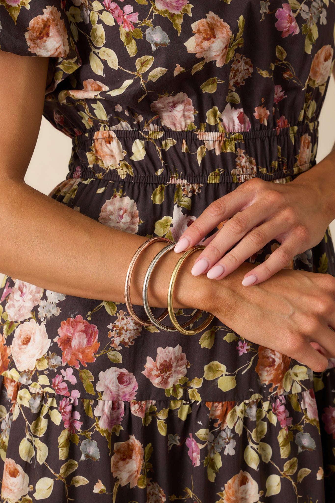 Shiny round bangles stacked for a sleek, modern jewelry look.