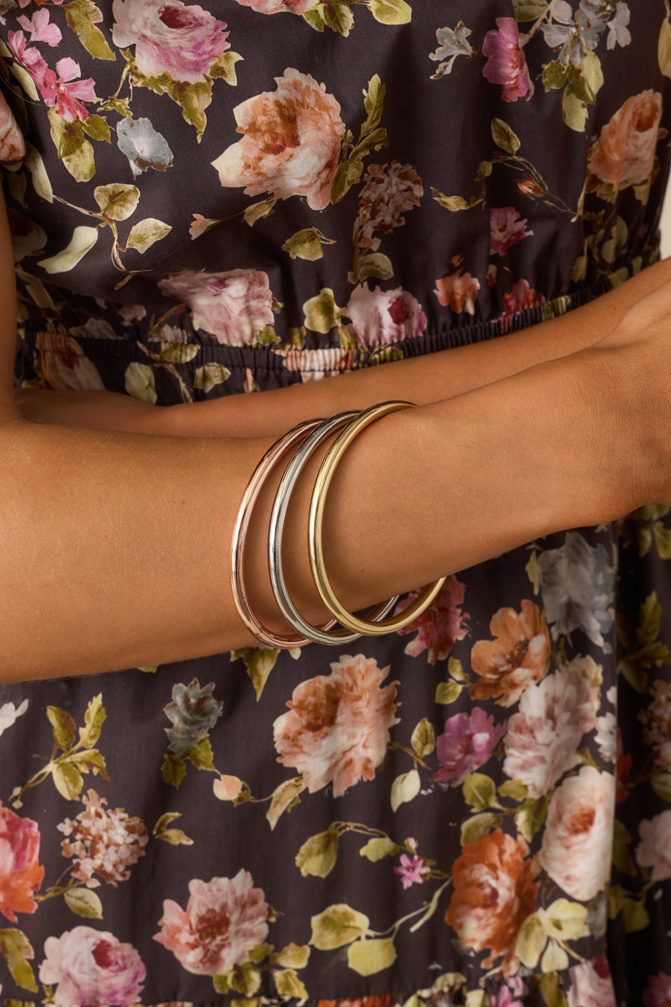 A trio of polished metal-tone round bangles with a slip-on design.
