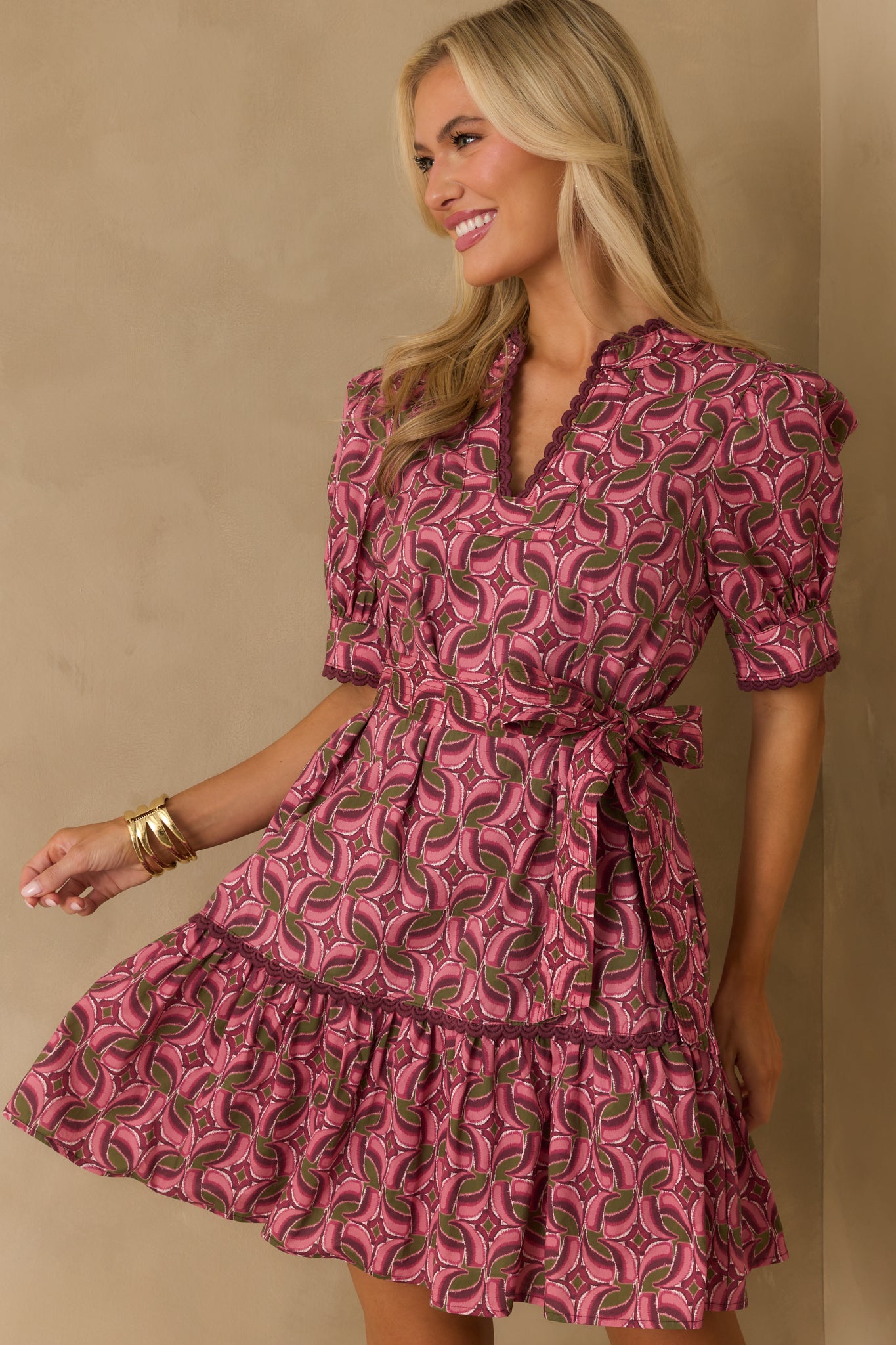 Cropped image focusing on the notch v-neckline framed by purple embroidered scallop trim.