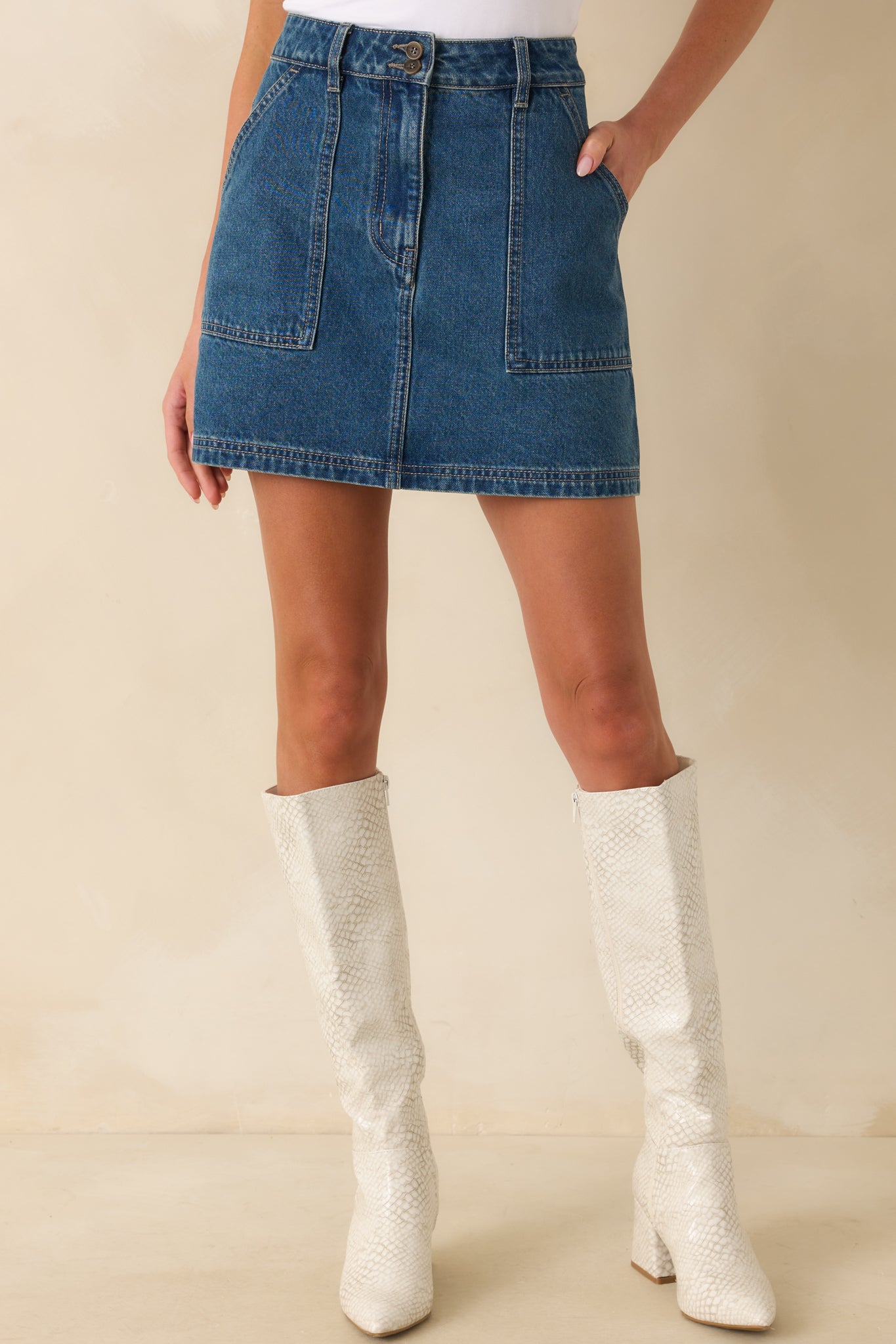 Cropped shot of the hemline and pocket placement on the mini skirt.