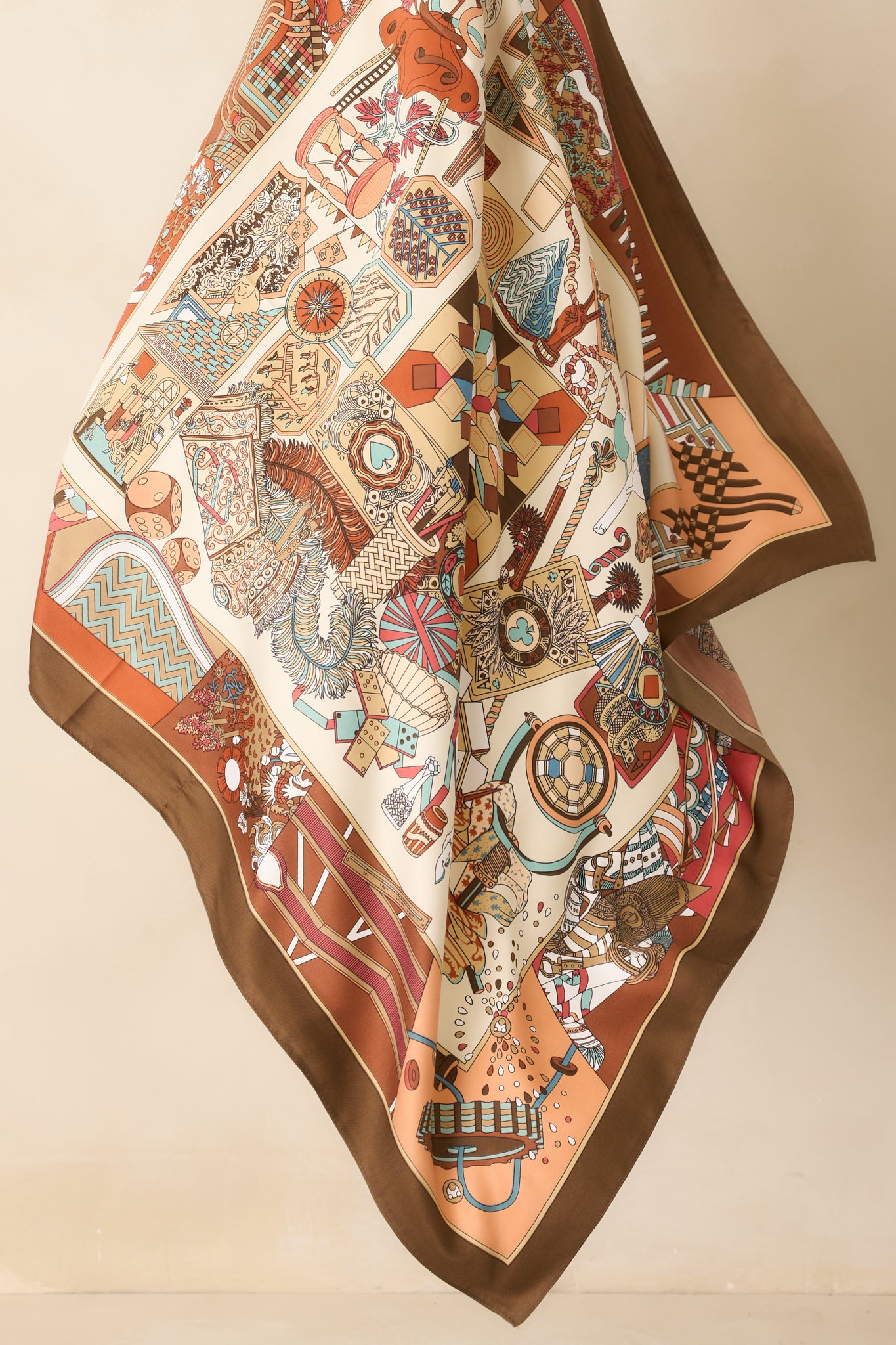 Angled image of the scarf laid out, emphasizing the sheen of the satin finish and the layered mix of patterns and colors.