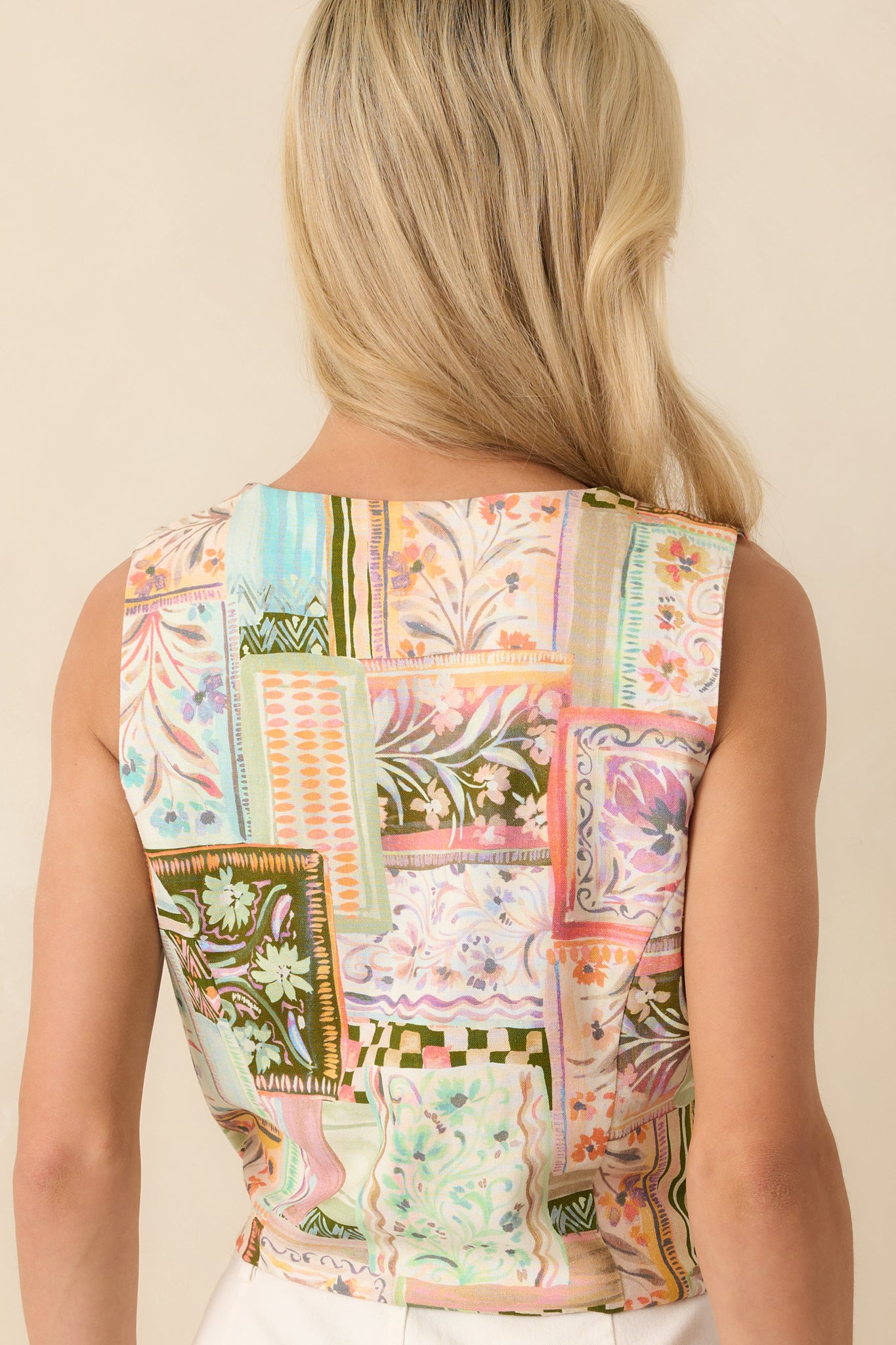A view from behind showing the simple sleeveless back design and the straight hem of the cropped vest.