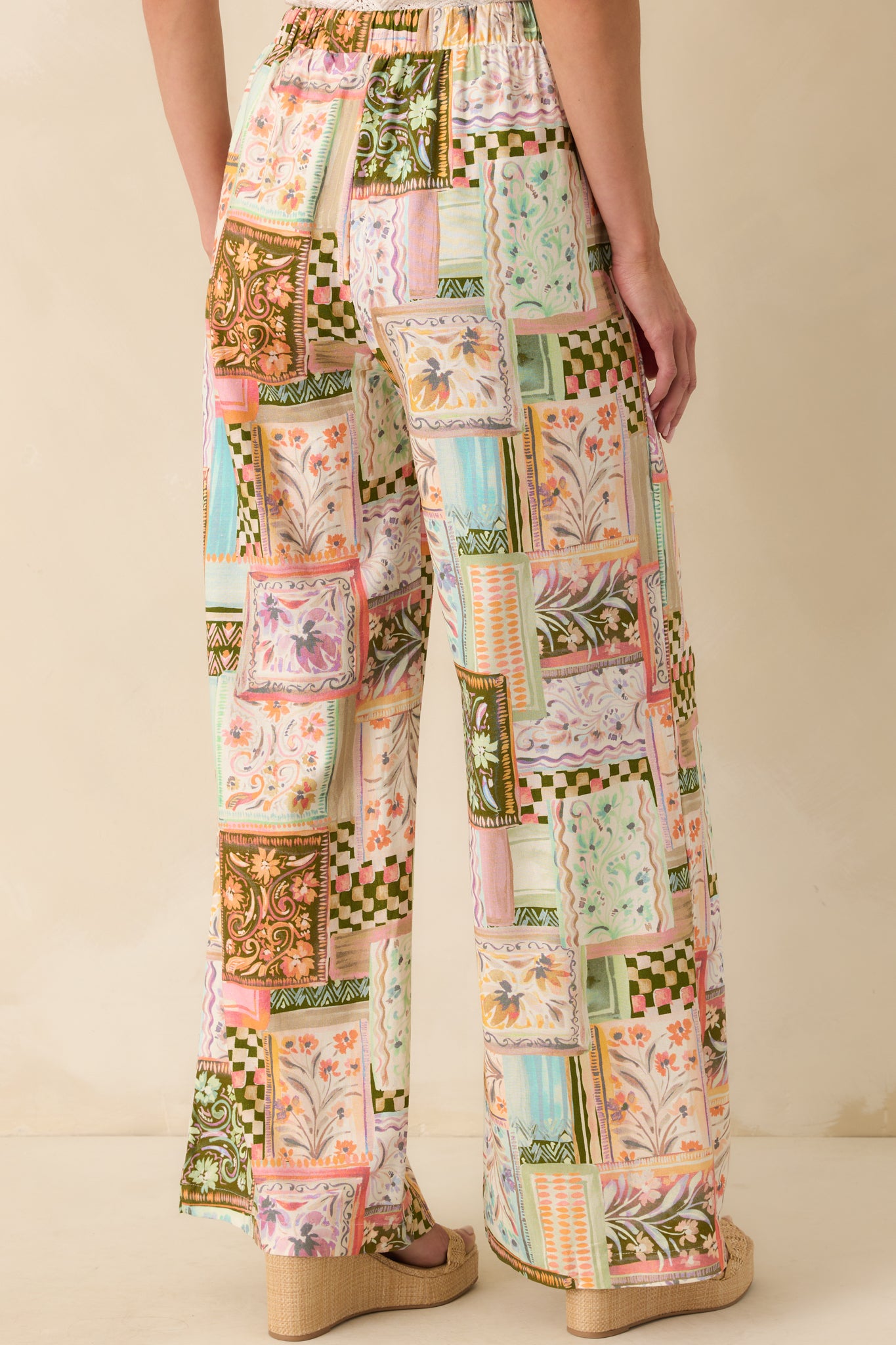 A view from behind showing the wide leg shape, high rise fit, and continuation of the multicolor patchwork print.