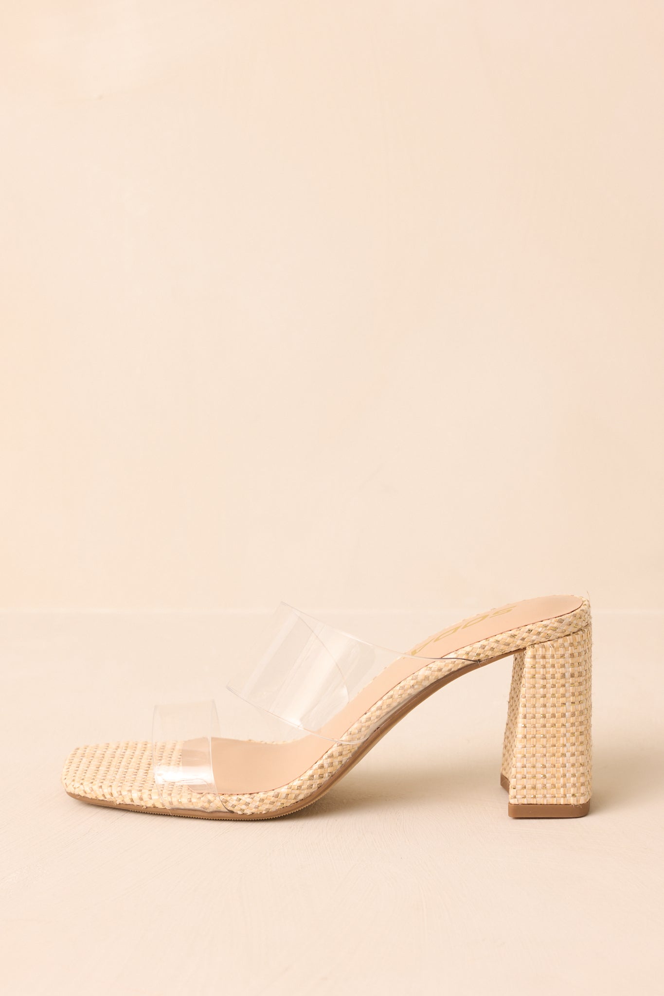 Side profile of raffia heels with block high heel on beige background.