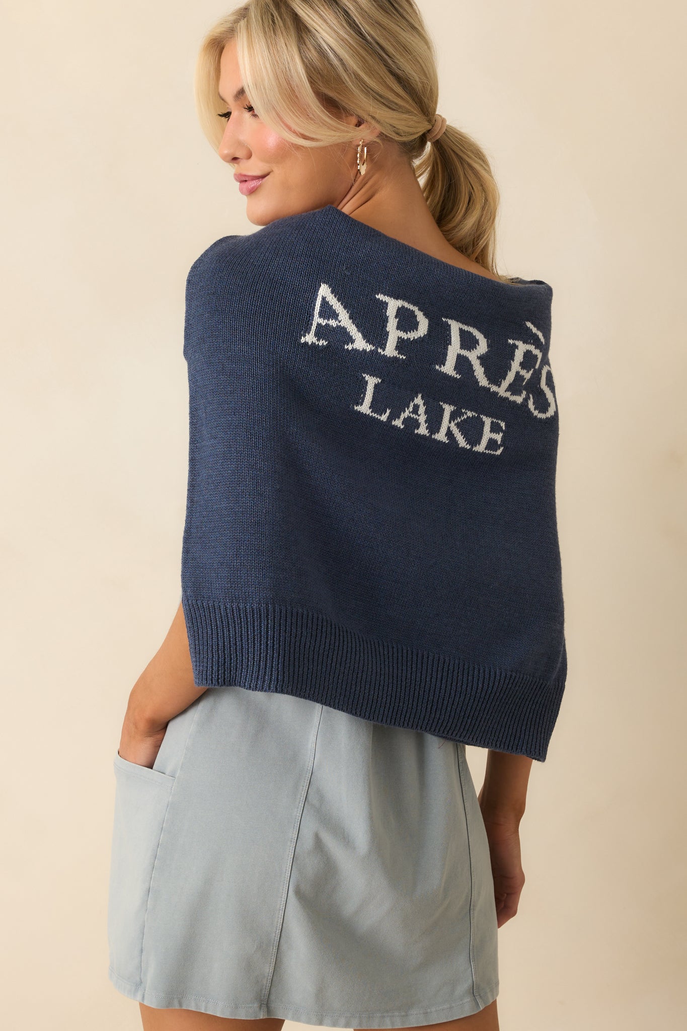 Close up of the navy pullover showing sleeve ribbing detail with the white front lettering.