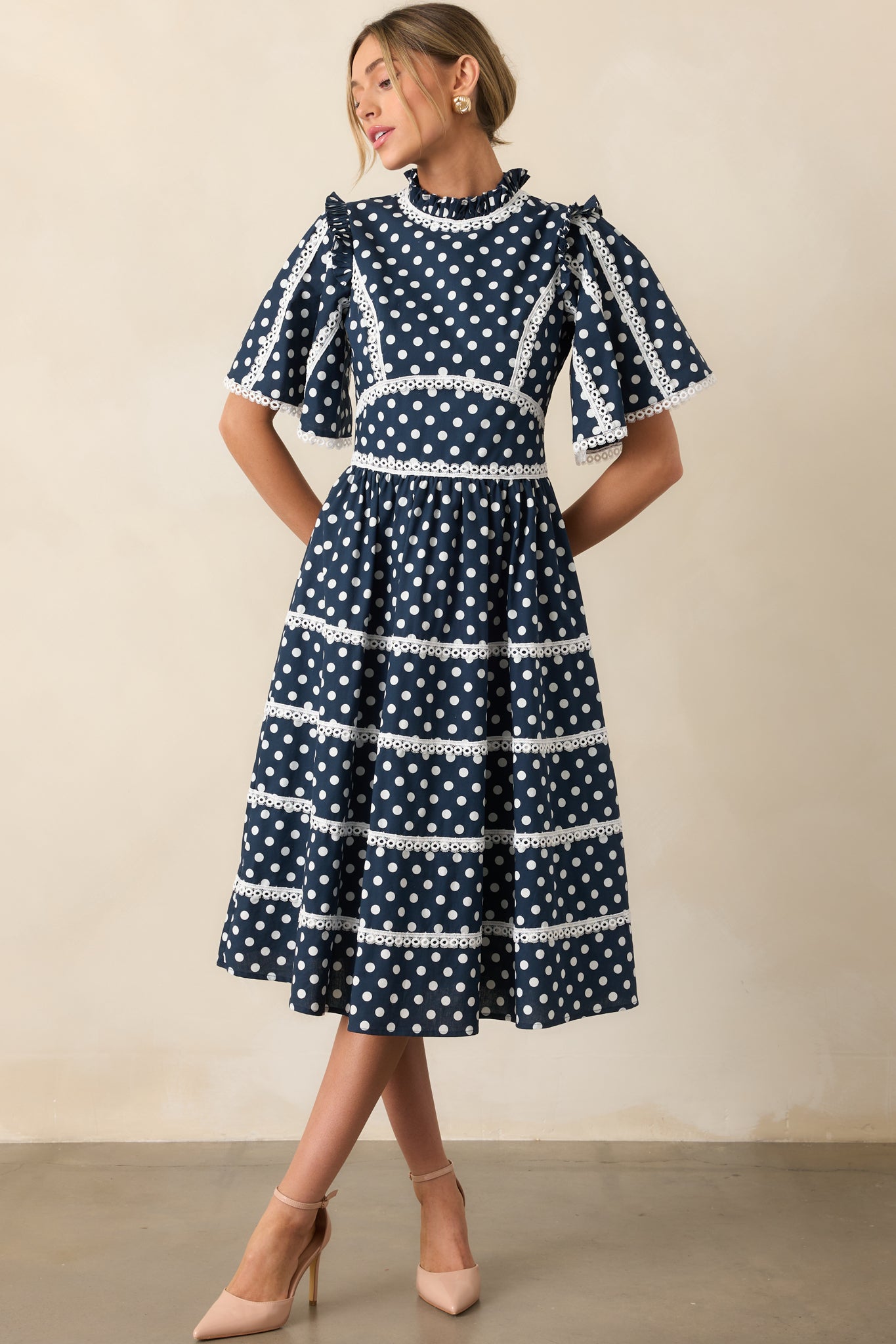 Front view of tiered midi dress with white eyelet trim and butterfly sleeves.