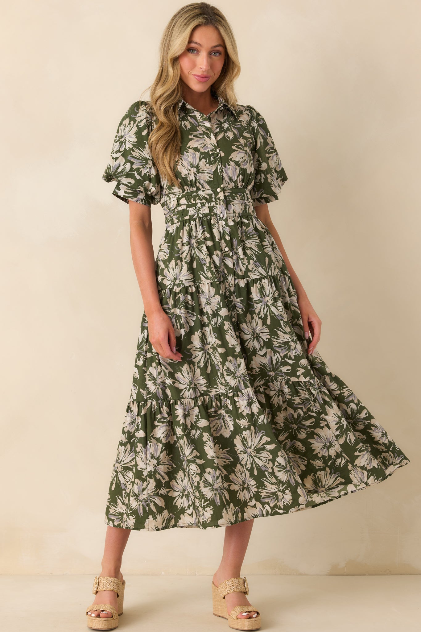 Angled full body image emphasizing the dress’s maxi length, floral print, and relaxed yet structured silhouette.