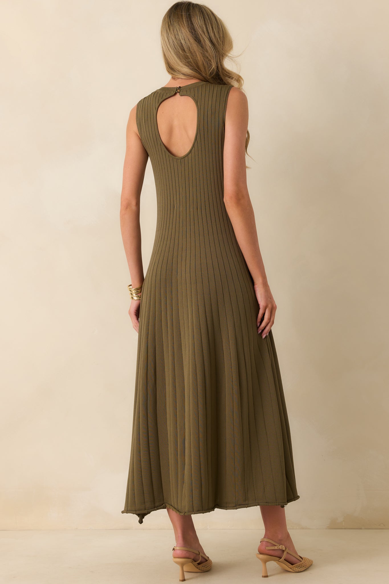 Rear view of olive green midi dress with open back button closure and ribbed fitted bodice.