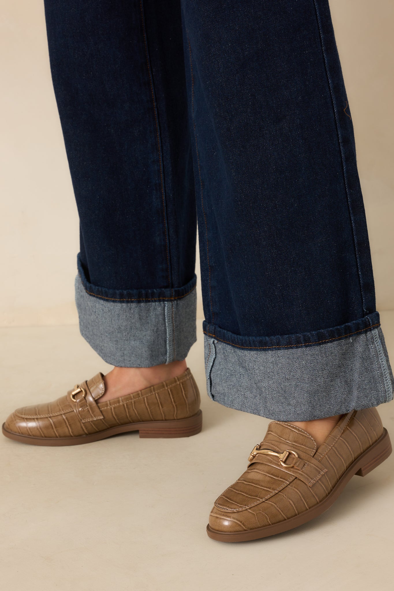 Top-down angled view showing both loafers’ structured almond toes and gold-tone hardware.