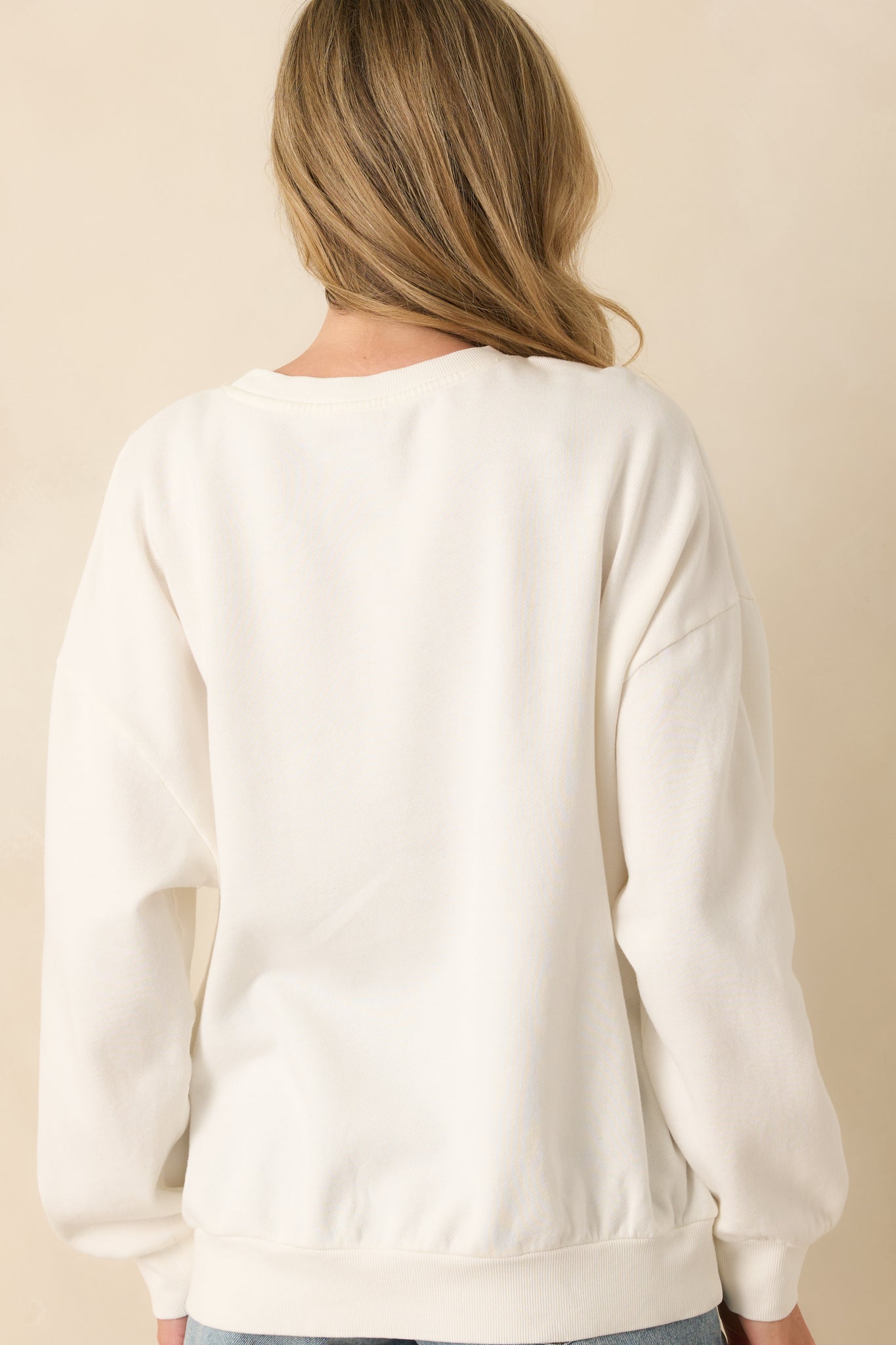 Rear view of oversized vintage wash sweatshirt with long sleeves and relaxed fit.
