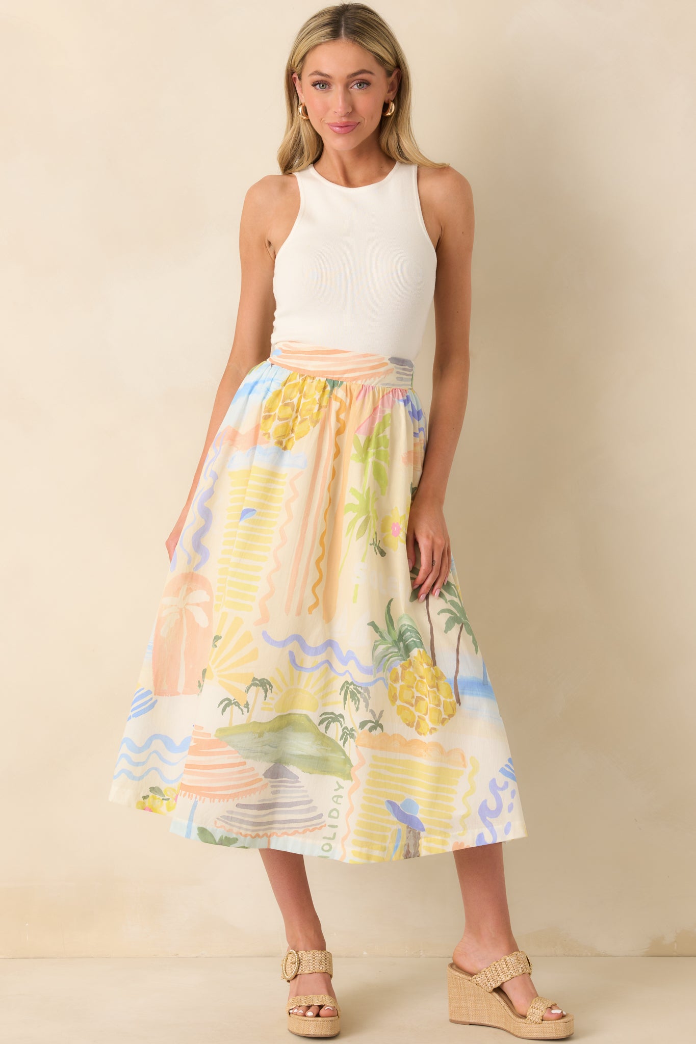 A full body shot highlighting the relaxed drape, bright print, and soft movement of the Citrus Splash midi skirt.