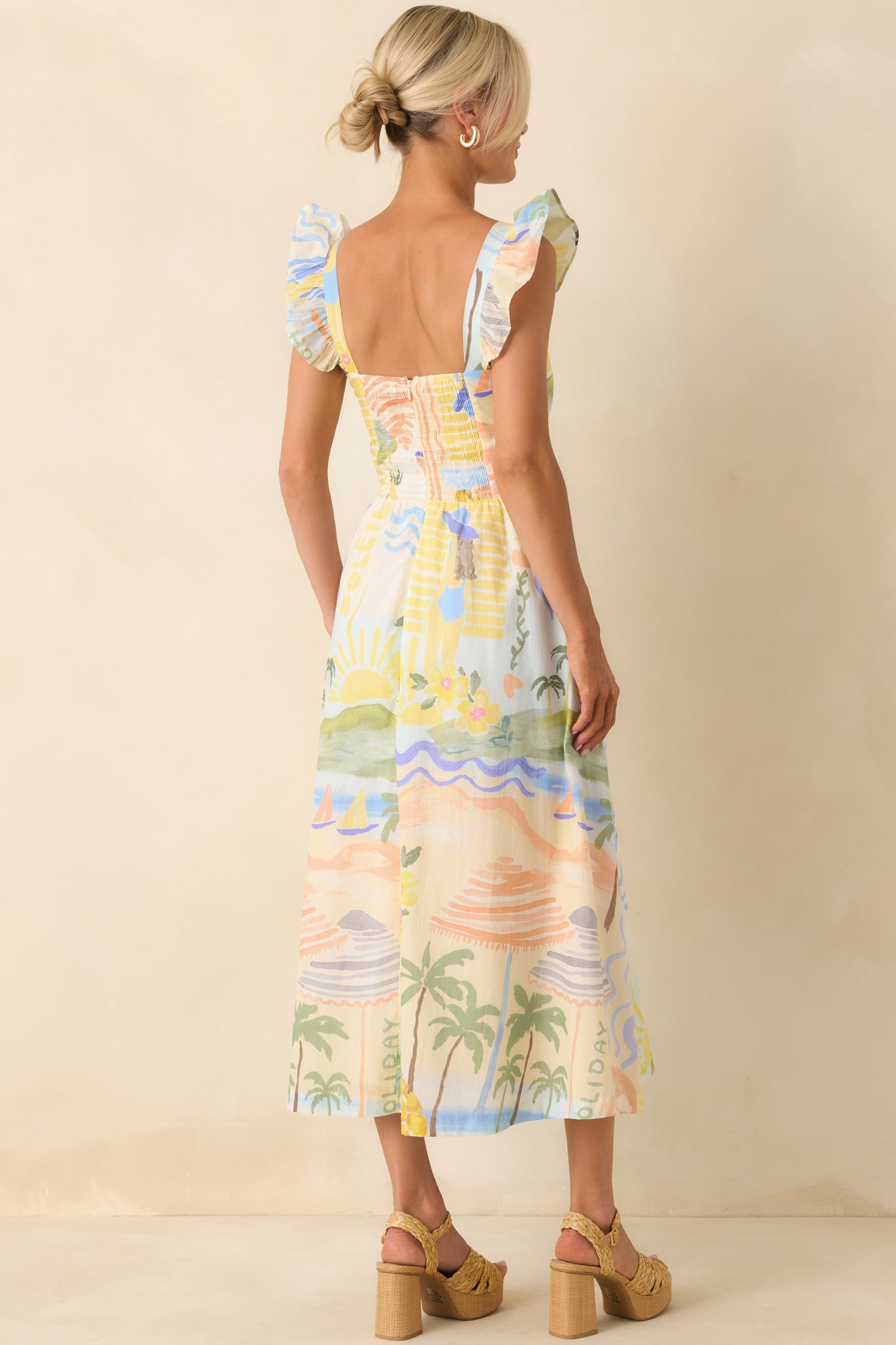Back view of tropical print midi dress featuring the smocked back panel and hidden back zipper closure.