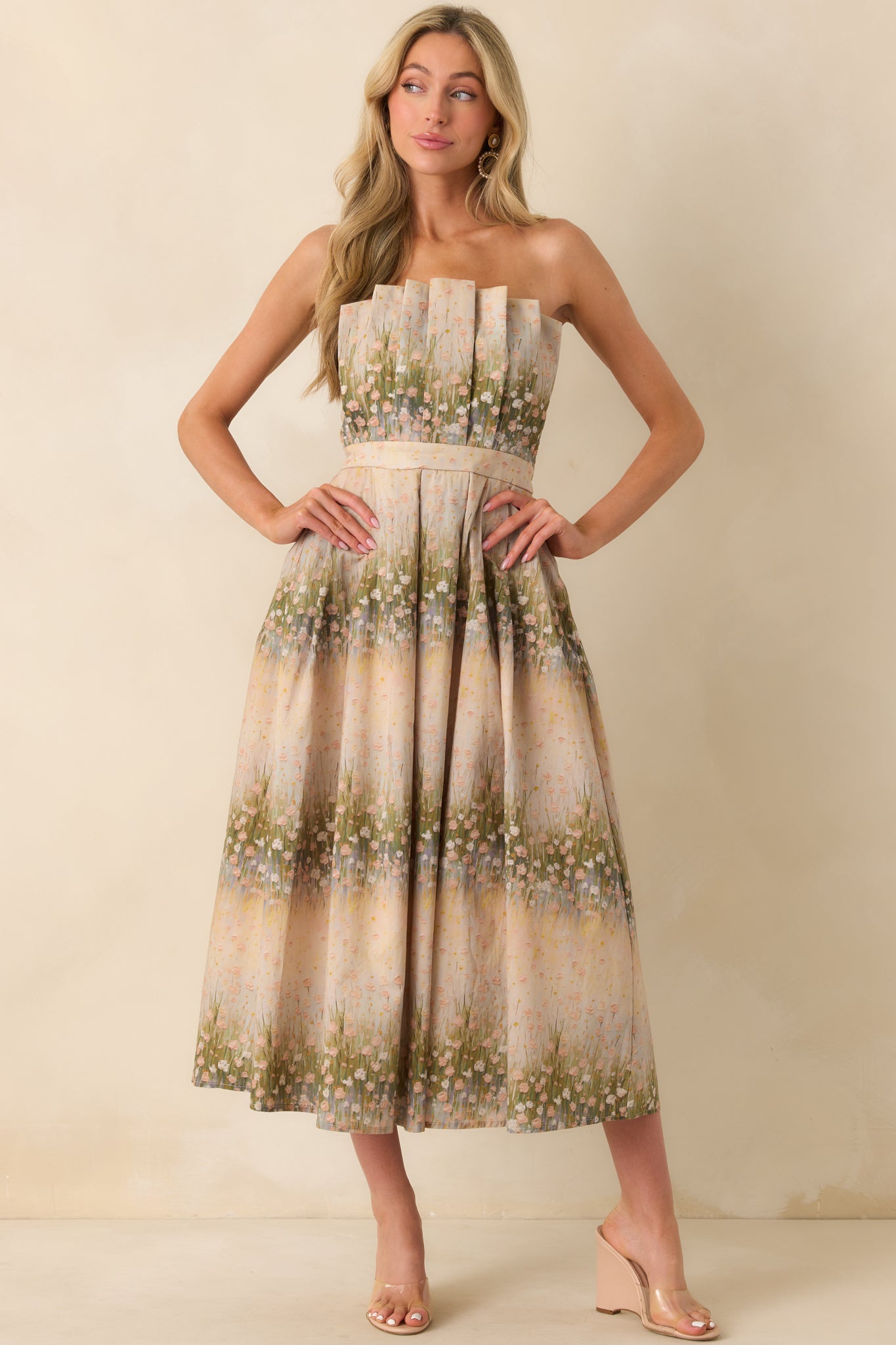 A full body front view of the beige dress featuring a green multicolor floral print and strapless neckline.