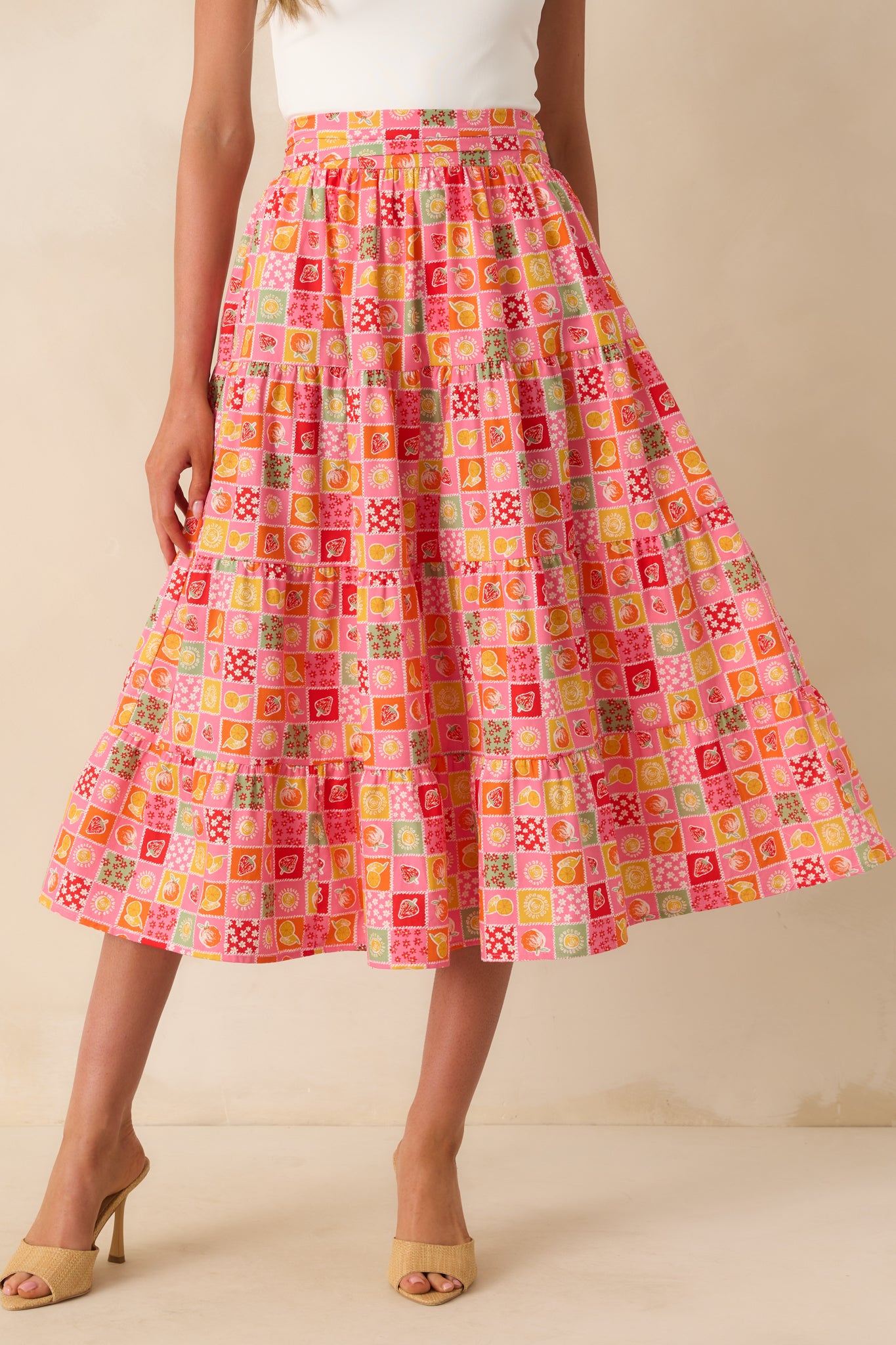 Wide view of the skirt styled with the self-tie bow visible at the waist and the patchwork print throughout.
