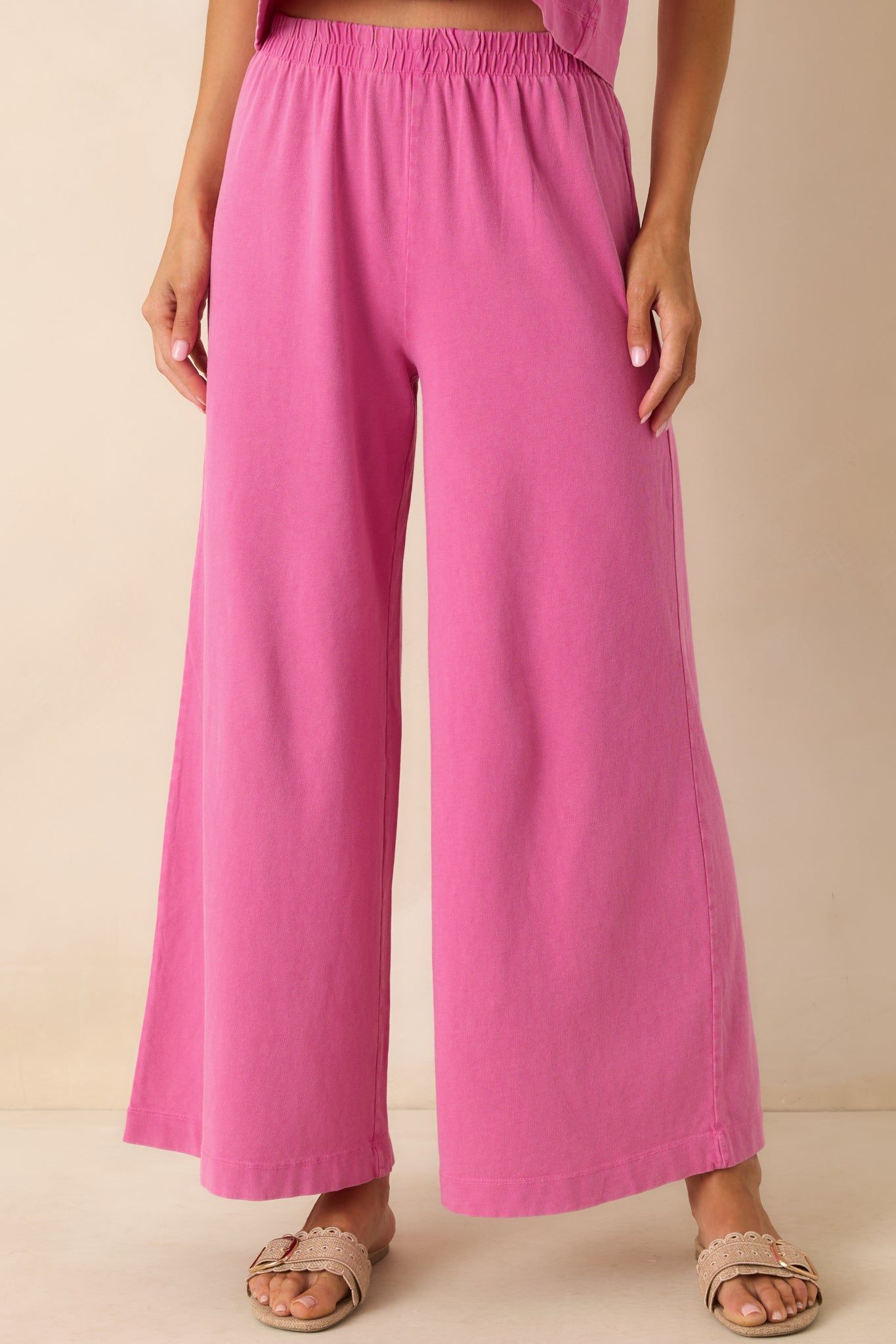 Cropped shot highlighting the drape and movement of one wide pant leg.