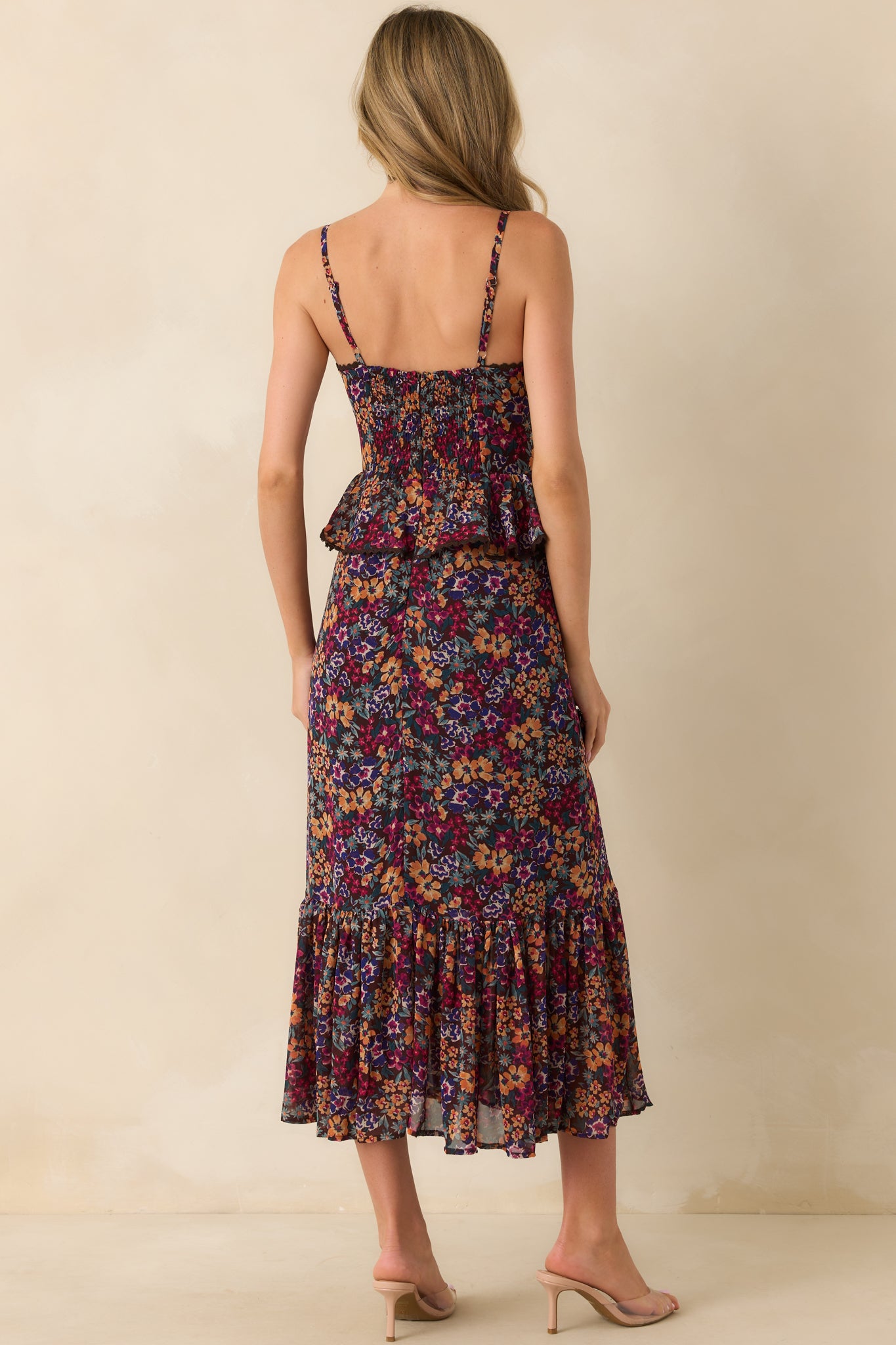 Back view of plum maxi dress with hidden zipper, smocked back panel, adjustable straps, and tiered skirt.